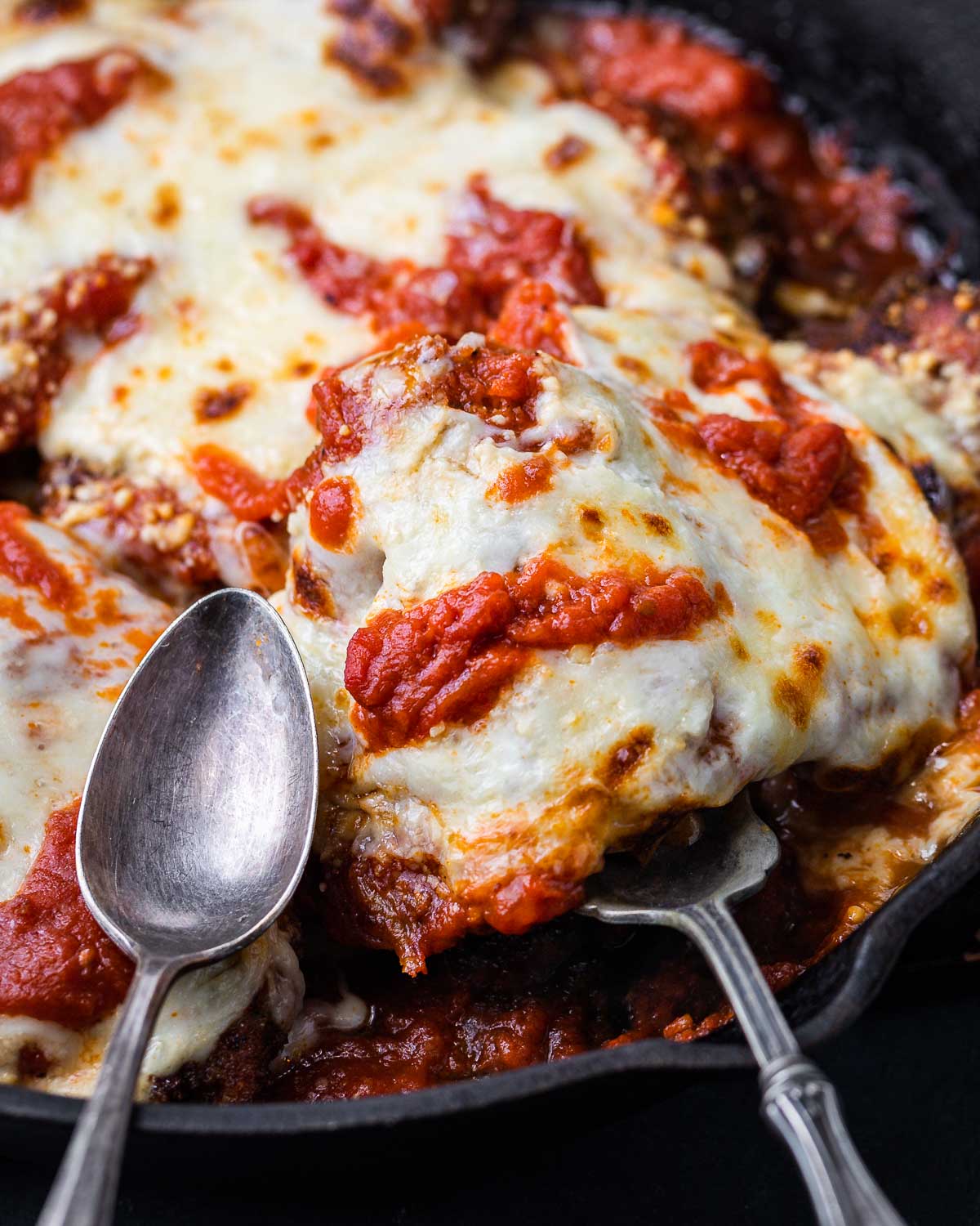 Chicken parmigiana scooped out of pan.