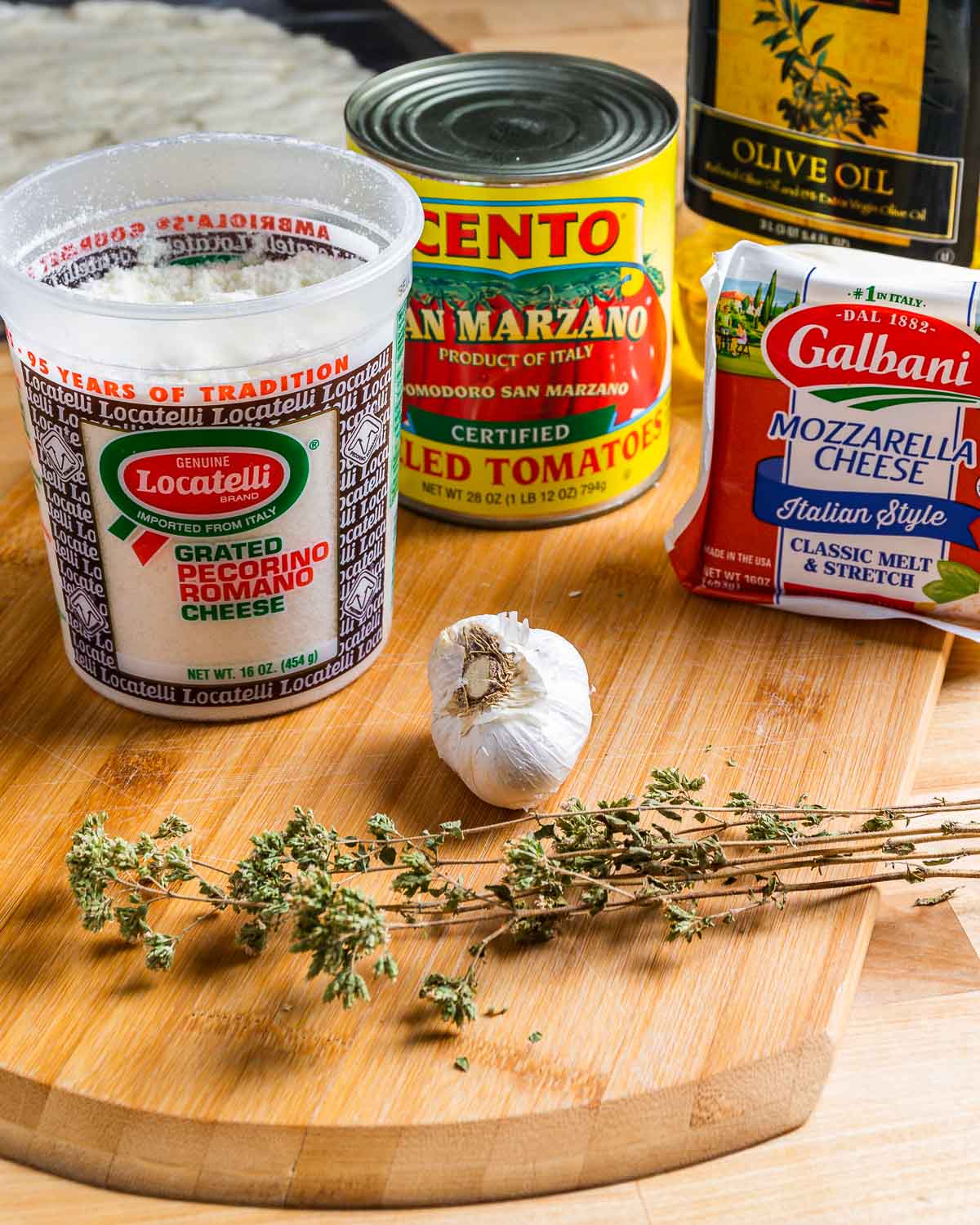 Ingredients shown: Locatelli Pecorino Romano, San Marzano tomatoes, mozzarella cheese, olive oil, garlic, and Sicilian oregano.