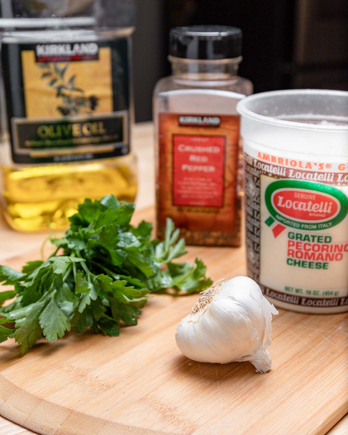 Ingredients shown: Olive oil, parsley, chili flakes, Pecorino Romano, and garlic.