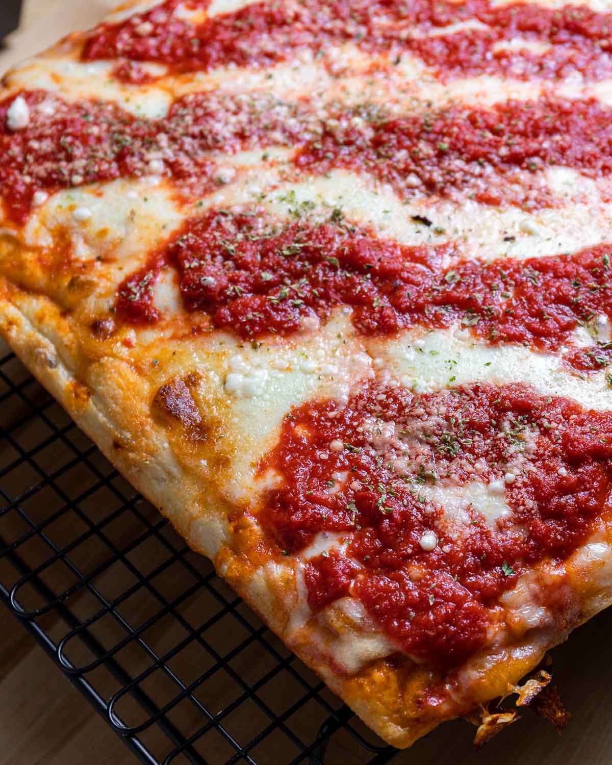 New York Sicilian pizza on wire rack.