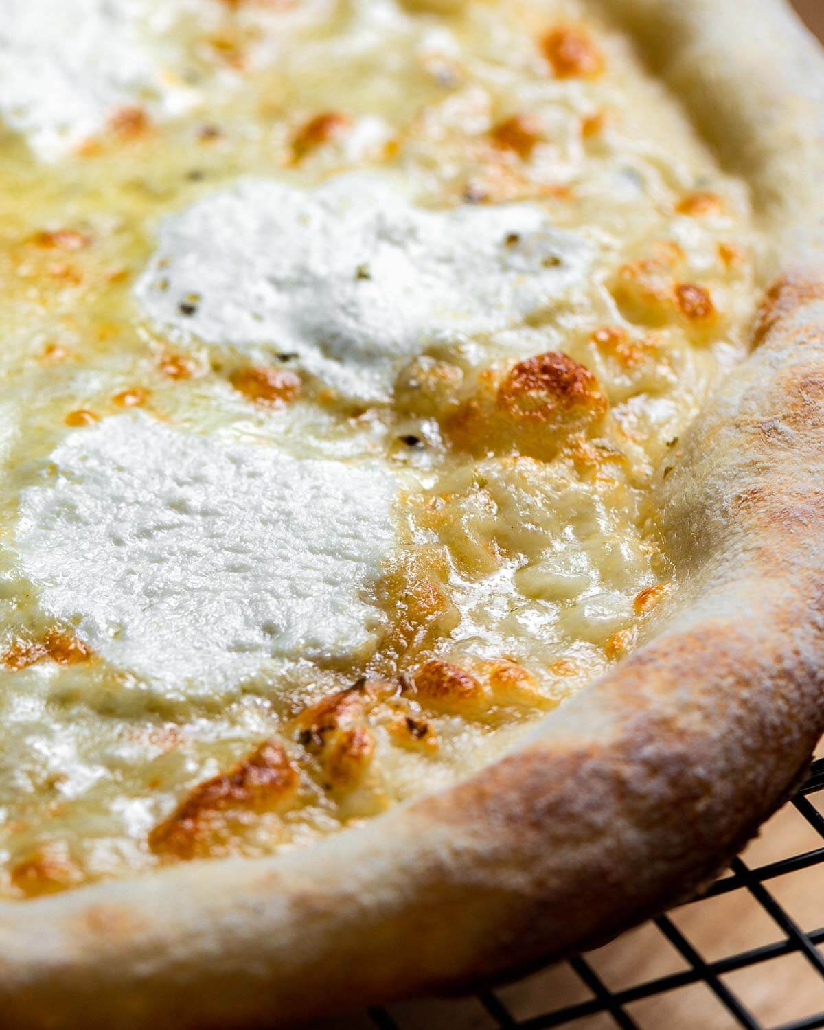 White pizza on wire rack.