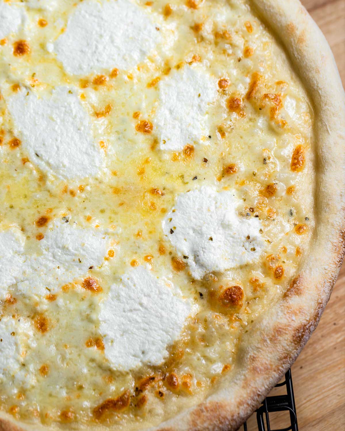 White pizza on wire rack.