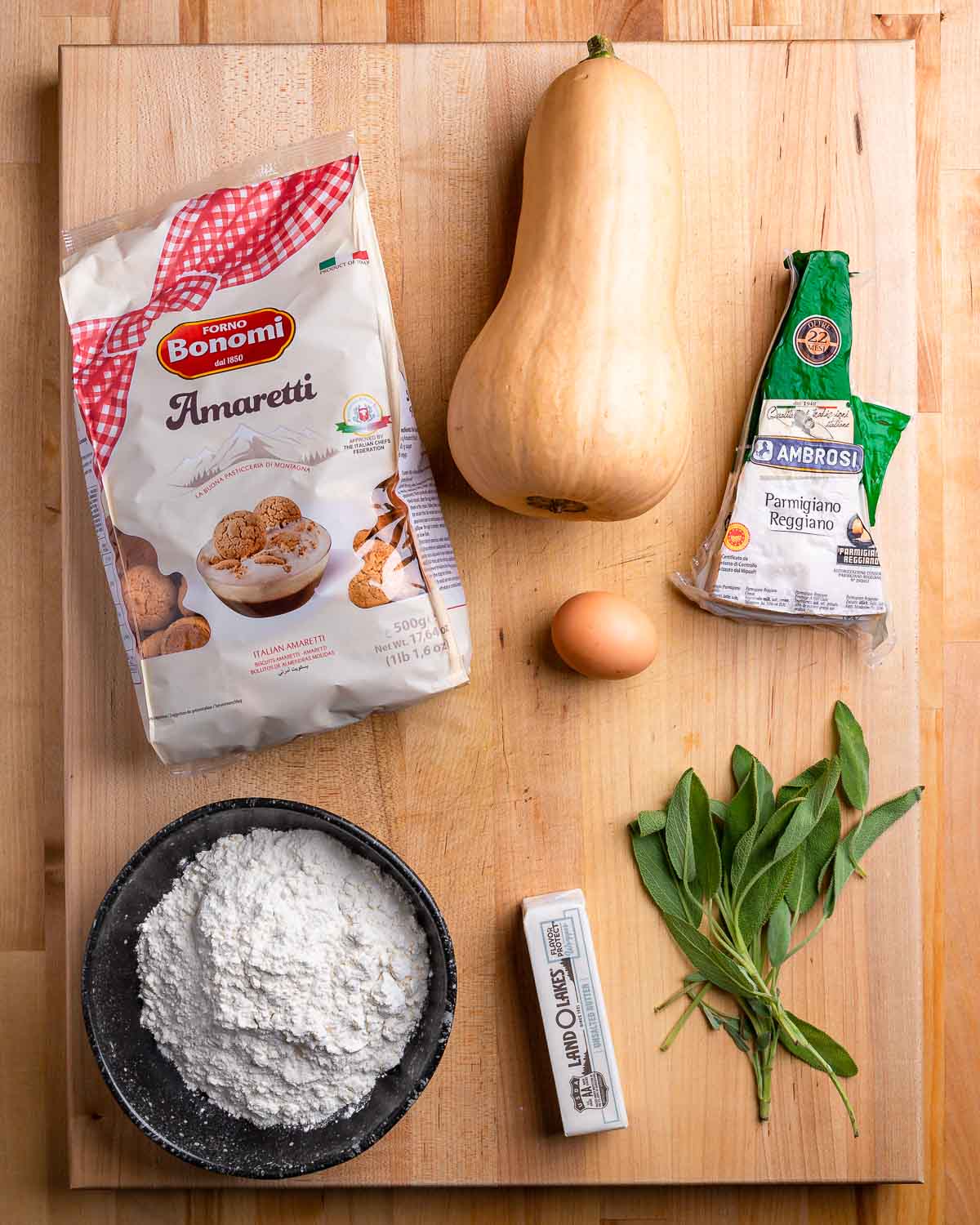 Ingredients shown: Amaretti cookie bag, butternut squash, Parmigiano Reggiano, egg, flour, butter, and sage.