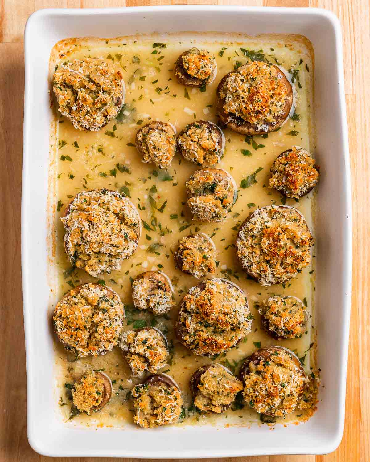 Overhead shot of baking dish with cooked Italian stuffed mushrooms.