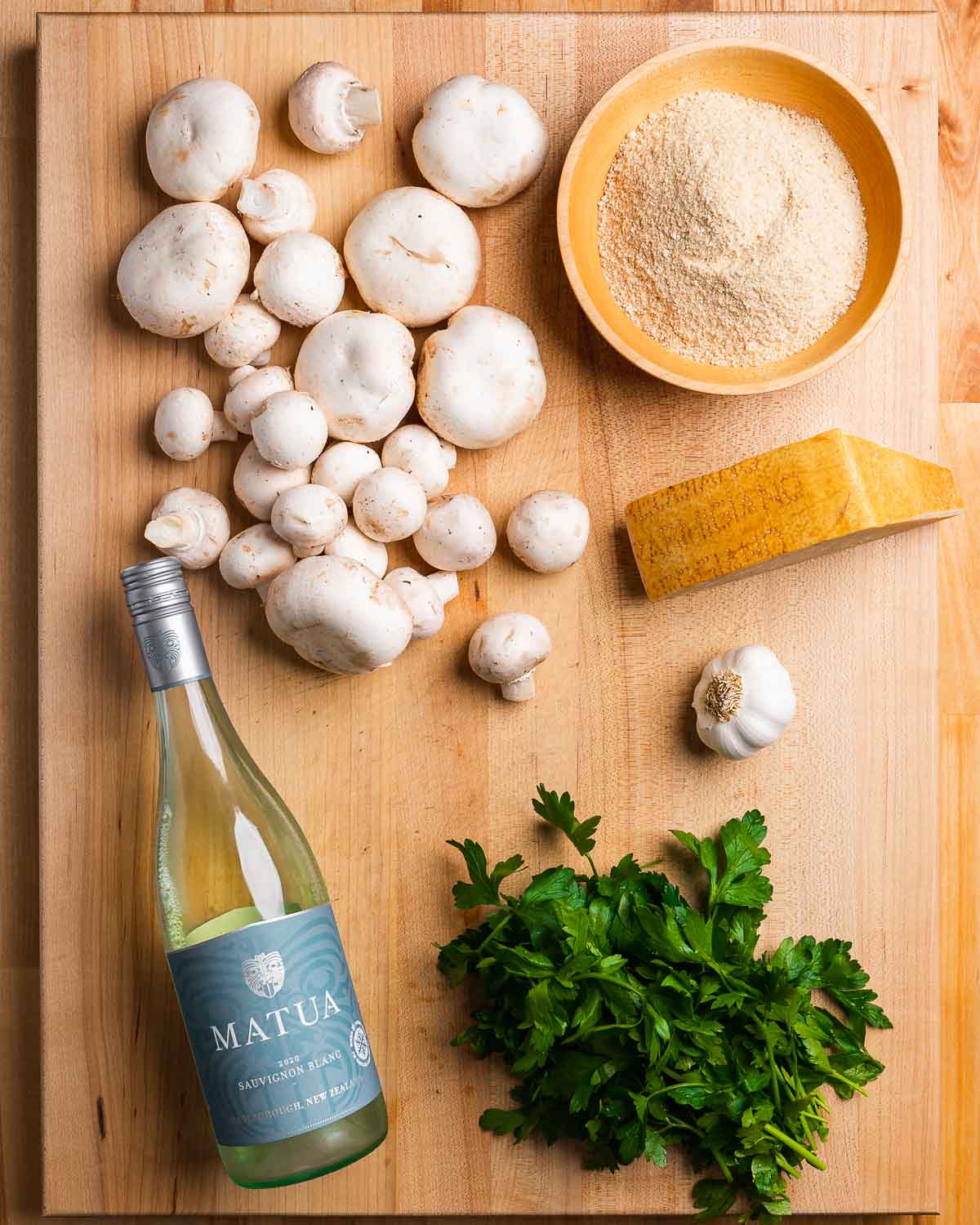 Ingredients shown: Loose mushrooms, breadcrumbs, white wine, parsley, garlic, and parmesan cheese.