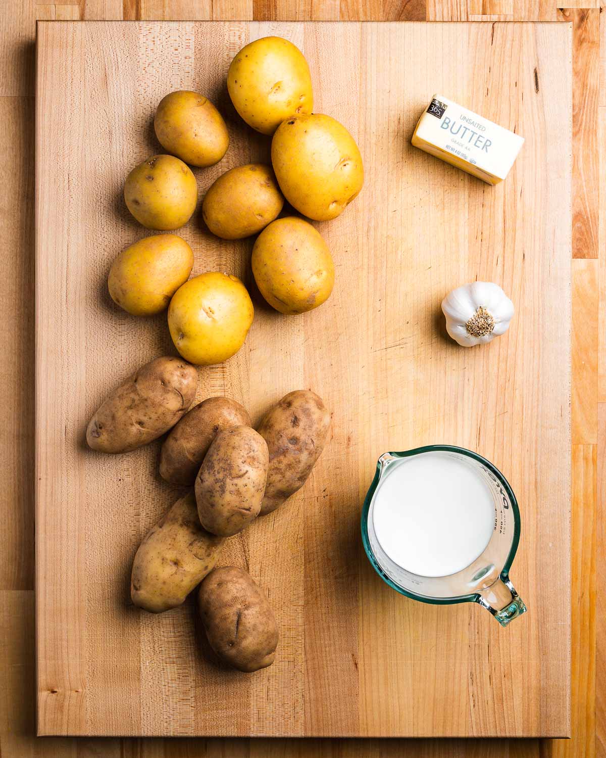 Ingredients shown: Yukon Gold potatoes, butter, garlic, milk, and russet potatoes.