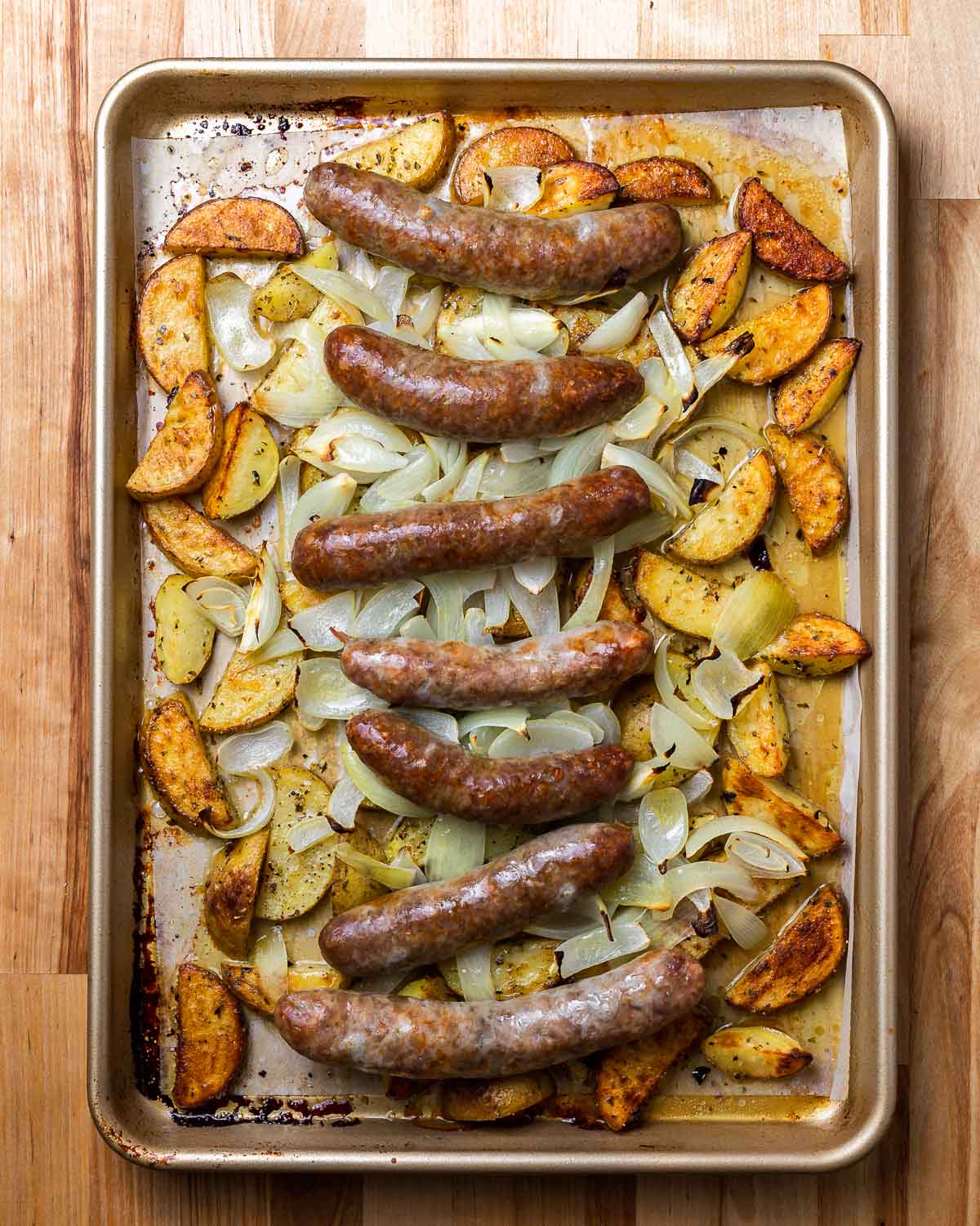 Overhead photo of cooked Italian sausage and potatoes.