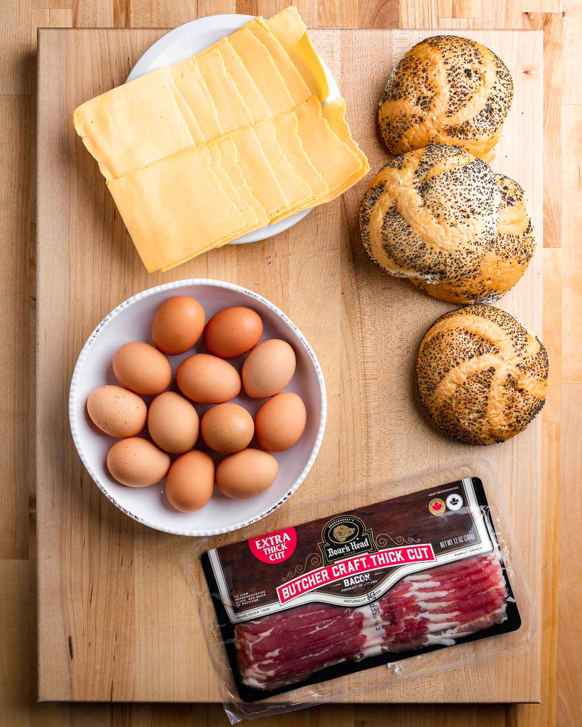 Ingredients shown: American cheese, deli rolls, eggs, and Boar's Head bacon.