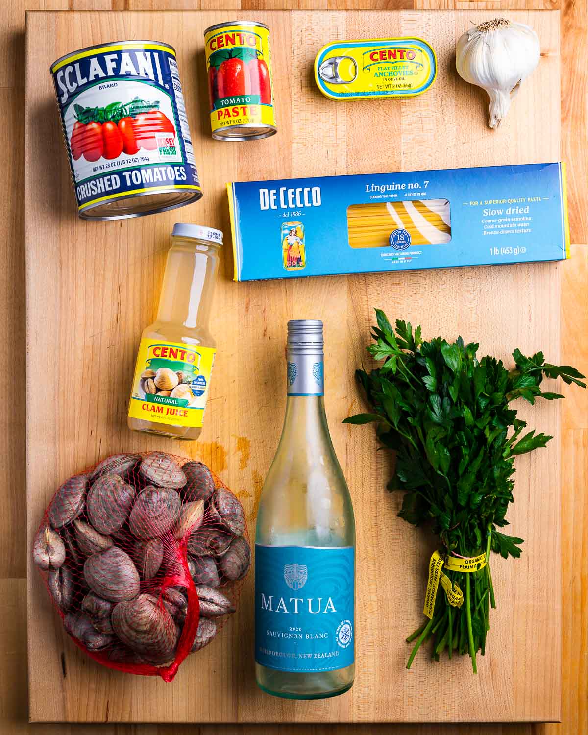 Ingredients shown: plum tomatoes, tomato paste, anchovies, garlic, linguine, clam juice, clams, wine, and parsley.