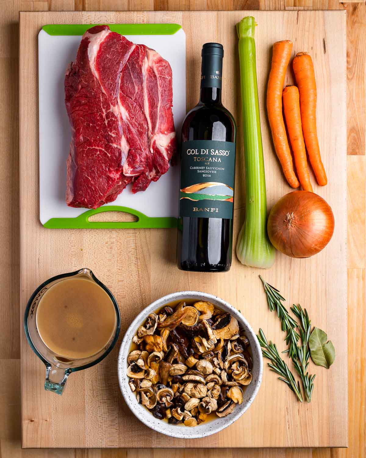 Ingredients shown: beef chuck, wine, celery, carrots, onion, beef stock, mushrooms, and herbs.