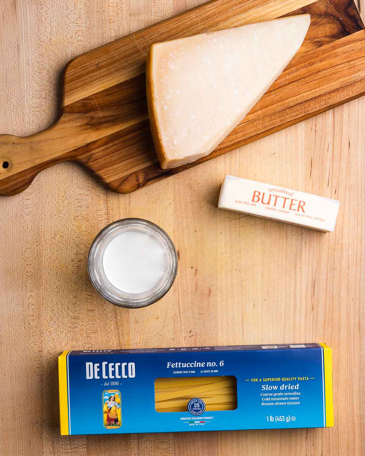 Ingredients shown: Parmigiano Reggiano, cream, butter, and fettuccine.