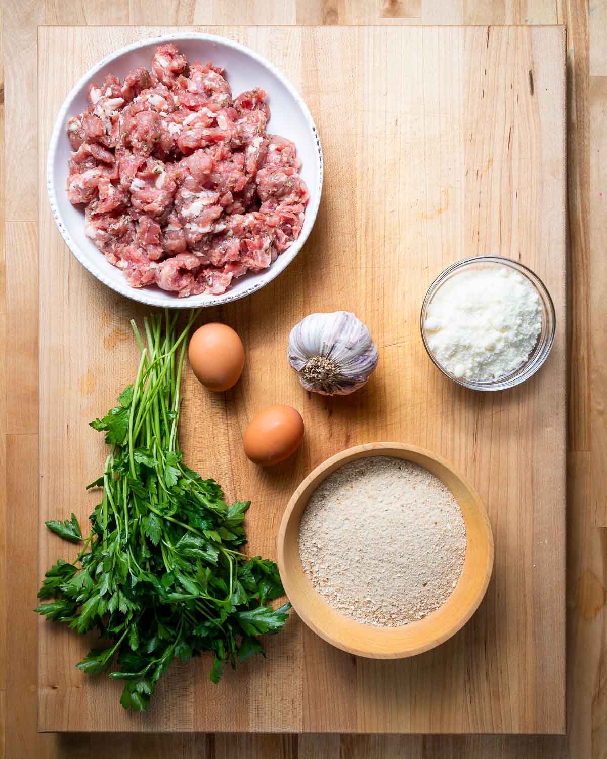 Ingredients shown: bulk sausage, parsley, eggs, garlic, and Pecorino Romano cheese.