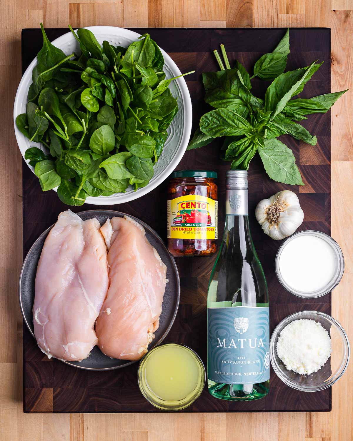 Ingredients shown: spinach, basil, sun dried tomatoes, chicken, wine, chicken stock, garlic, cream, and Pecorino Romano cheese.