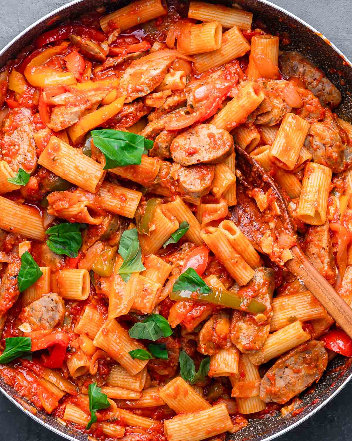 Overhead shot of large pan with sausage and peppers pasta.