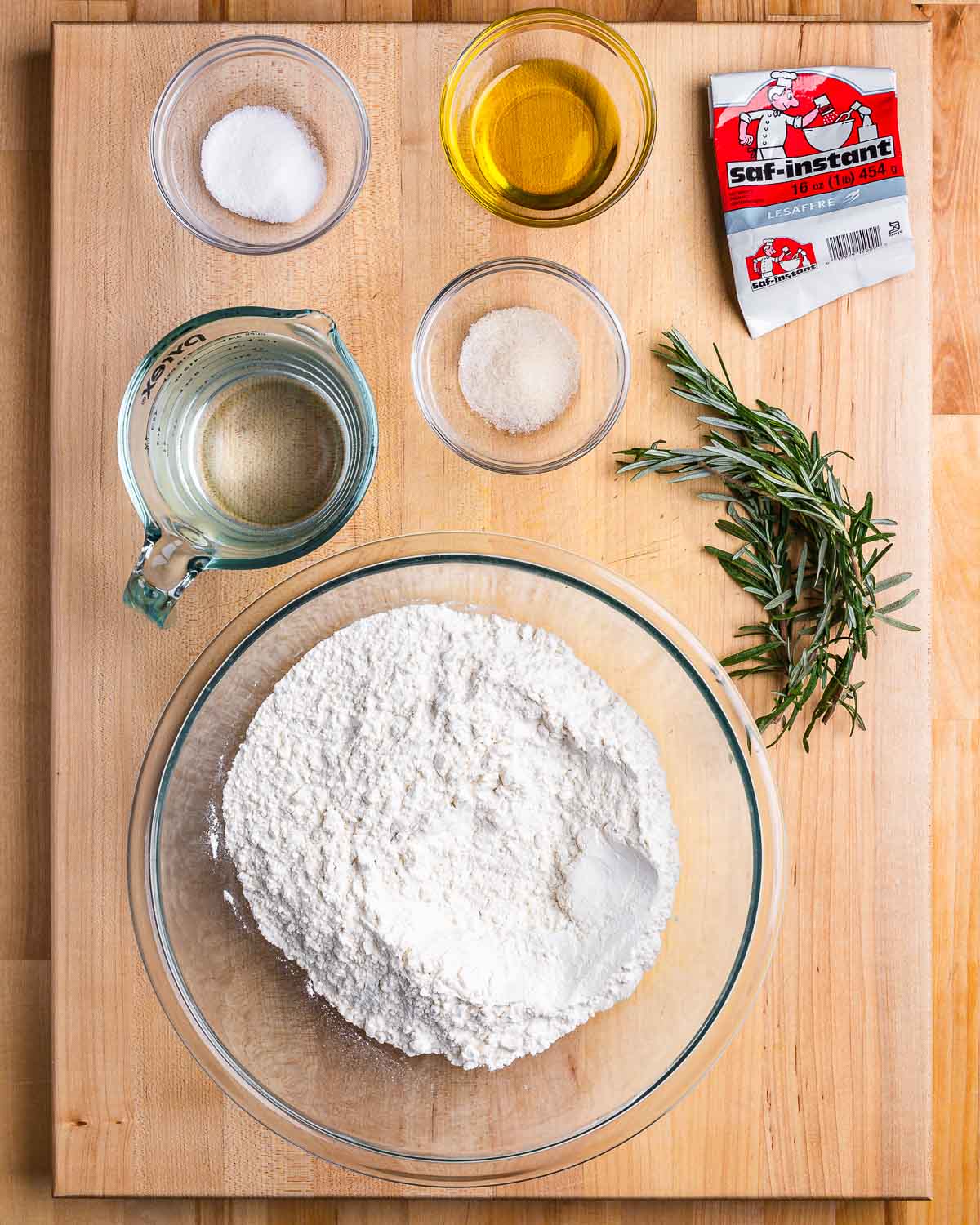 Ingredients shown: saf instant yeast, olive oil, salt, sugar, water, rosemary, and flour.