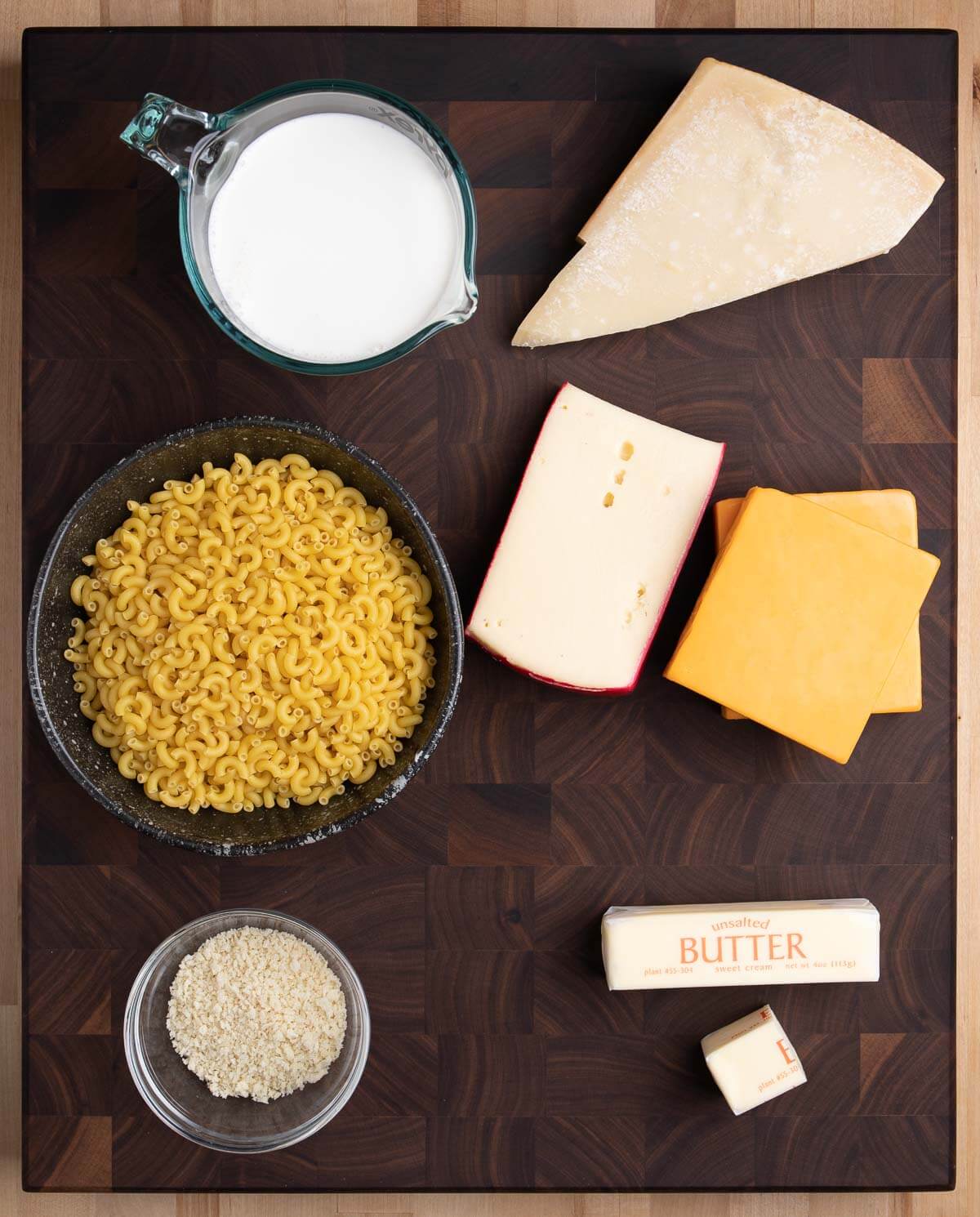 Ingredients shown: milk, Parmigiano, elbow macaroni, Fontina, cheddar, panko, and butter.