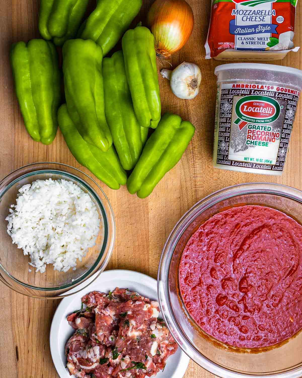 Ingredients shown: cubanelle peppers, onion, garlic, mozzarella, Pecorino, rice, sausage, and toamto sauce.
