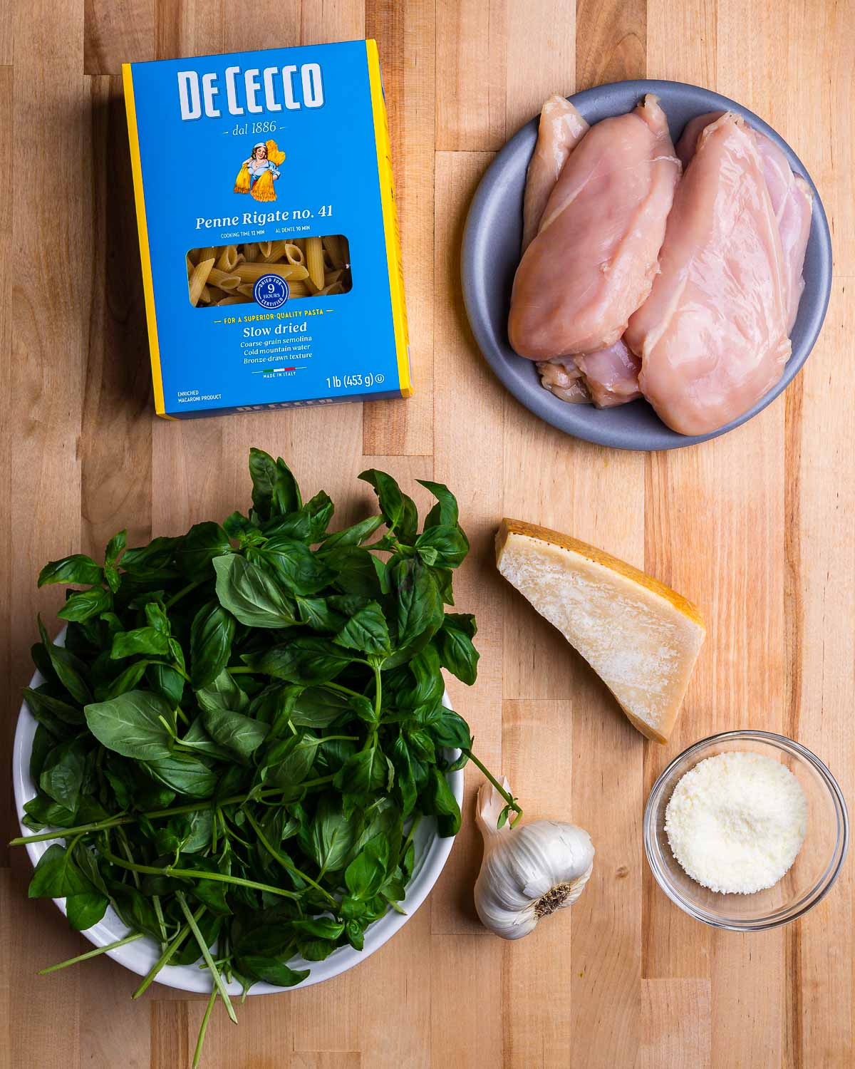 Ingredients shown: pasta, chicken breasts, basil, garlic, parmesan, and pecorino.