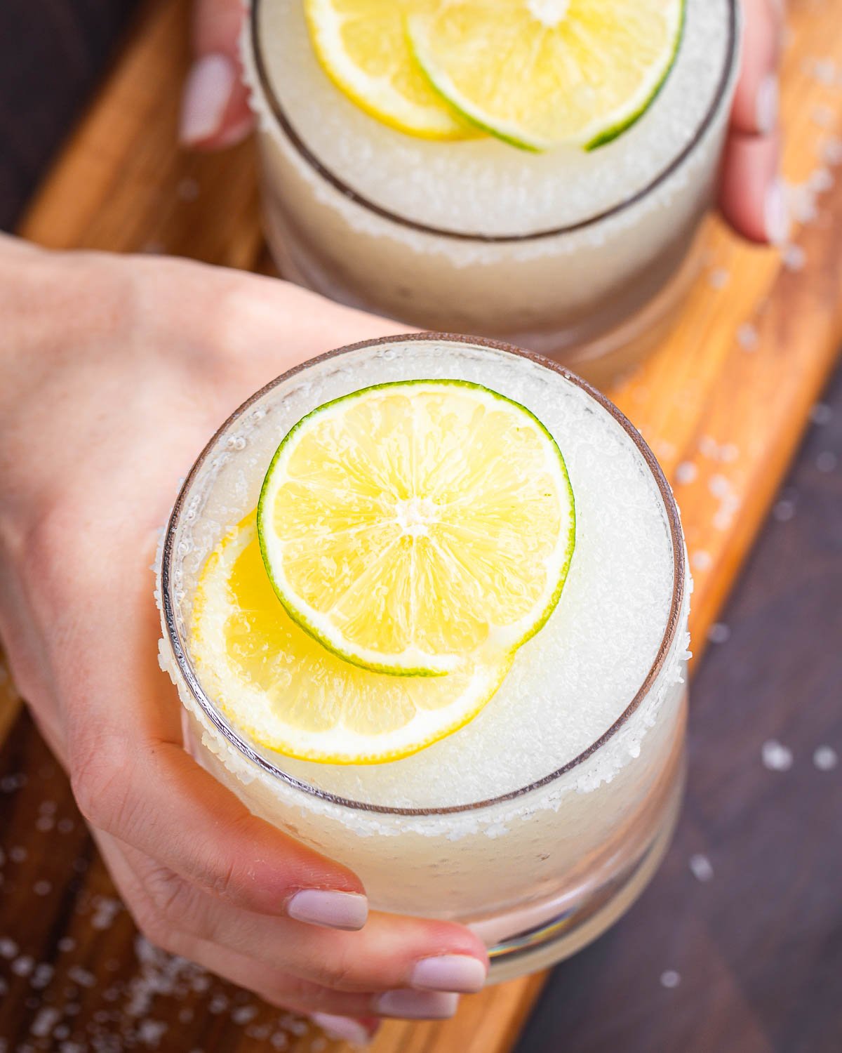 Limoncello margarita held in hands.