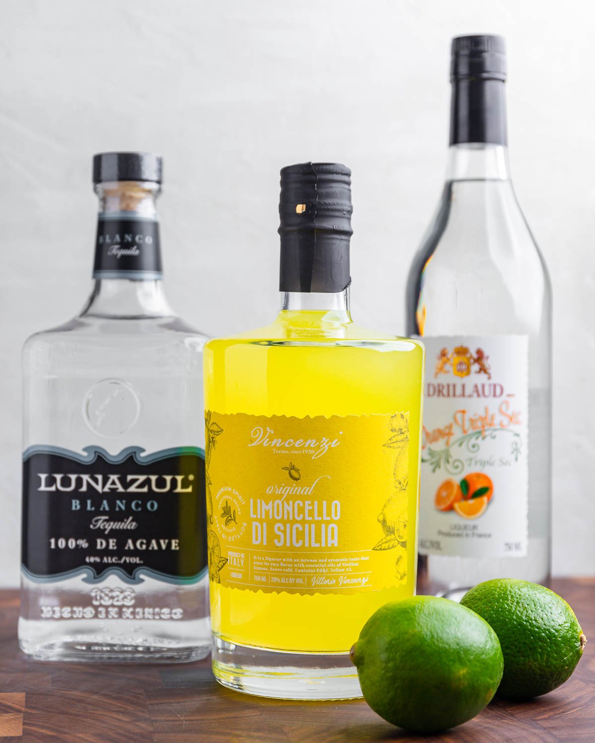 Ingredients shown: tequila, limoncello, triple sec, and limes.