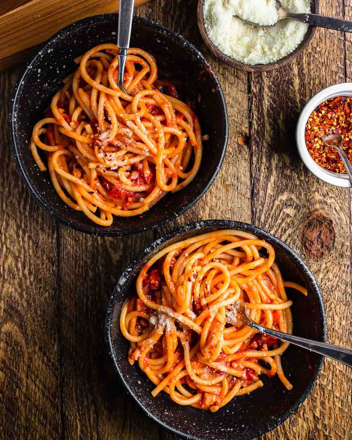 Overhead shot of two bowls of bucatini Amatriciana.