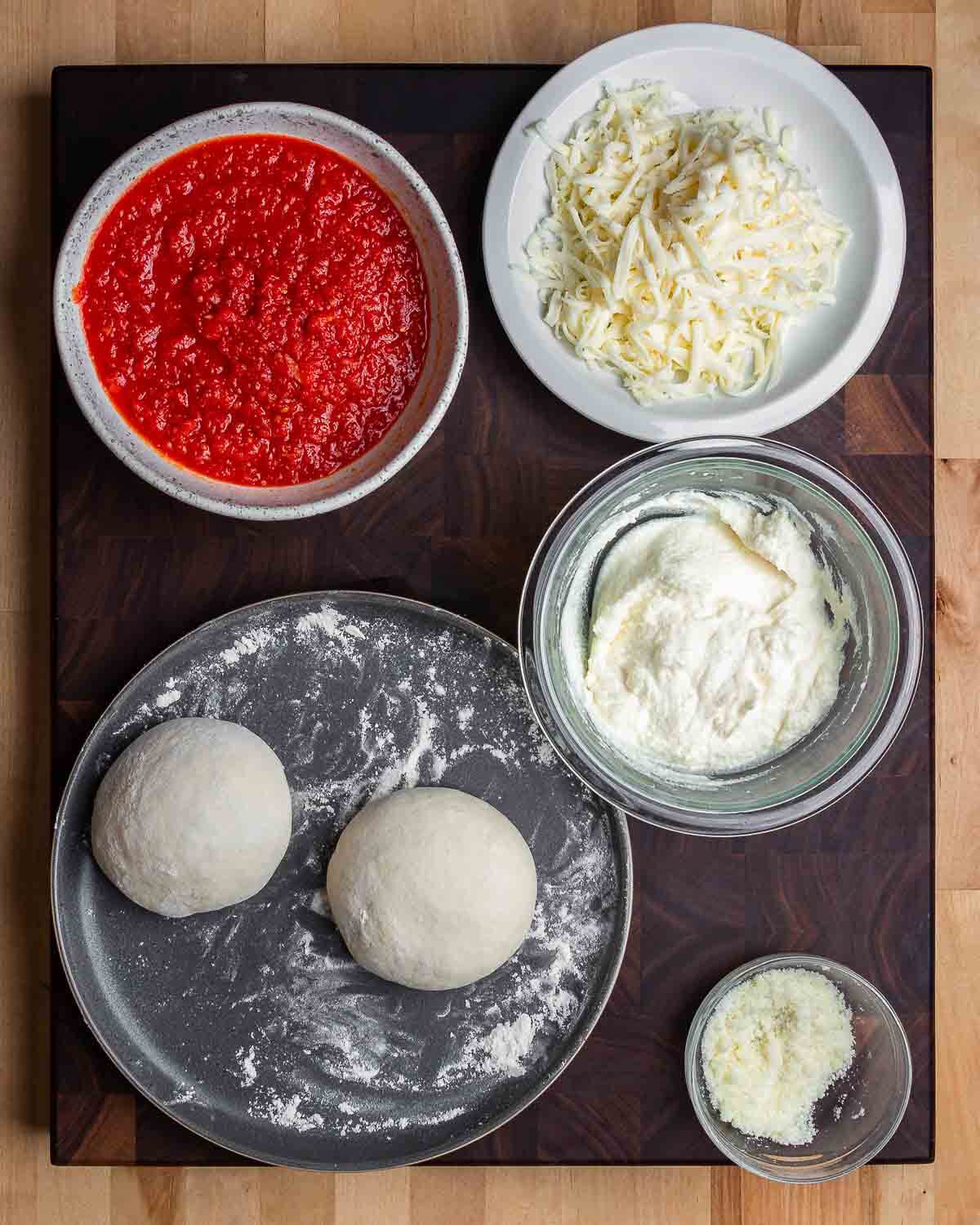 Ingredients shown: marinara, mozzarella, ricotta, 2 dough balls, and Pecorino Romano.