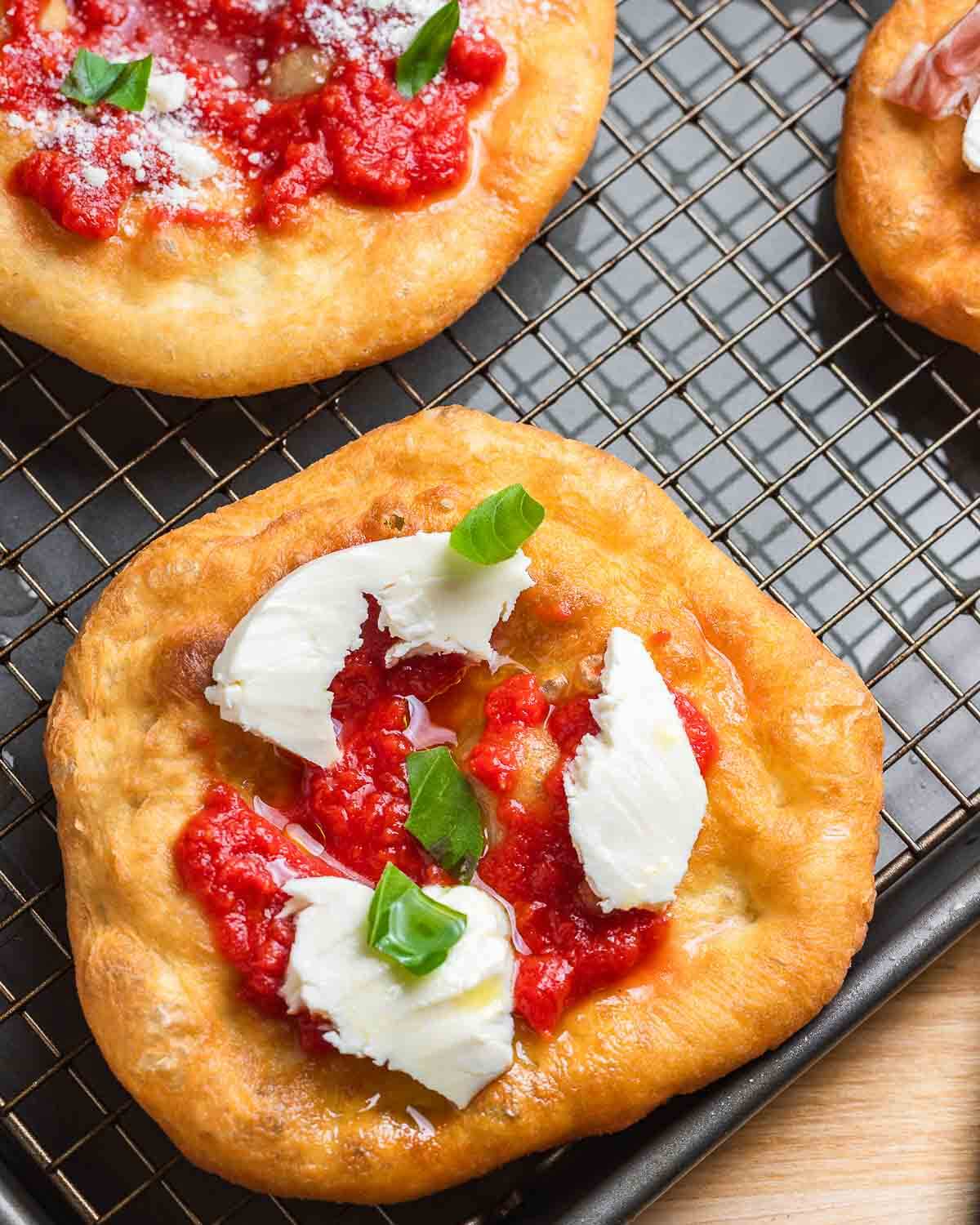 Pizza fritta with tomato, mozzarella, and basil.