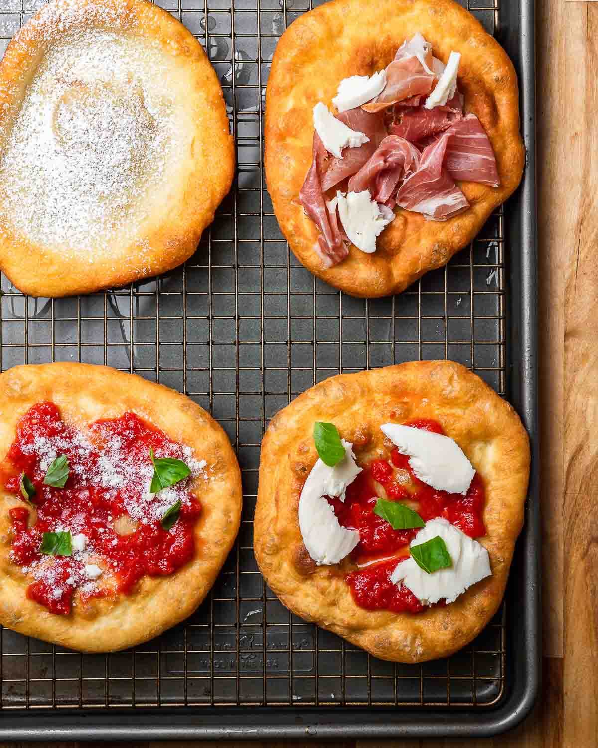 4 different pizza fritta versions on wire rack.