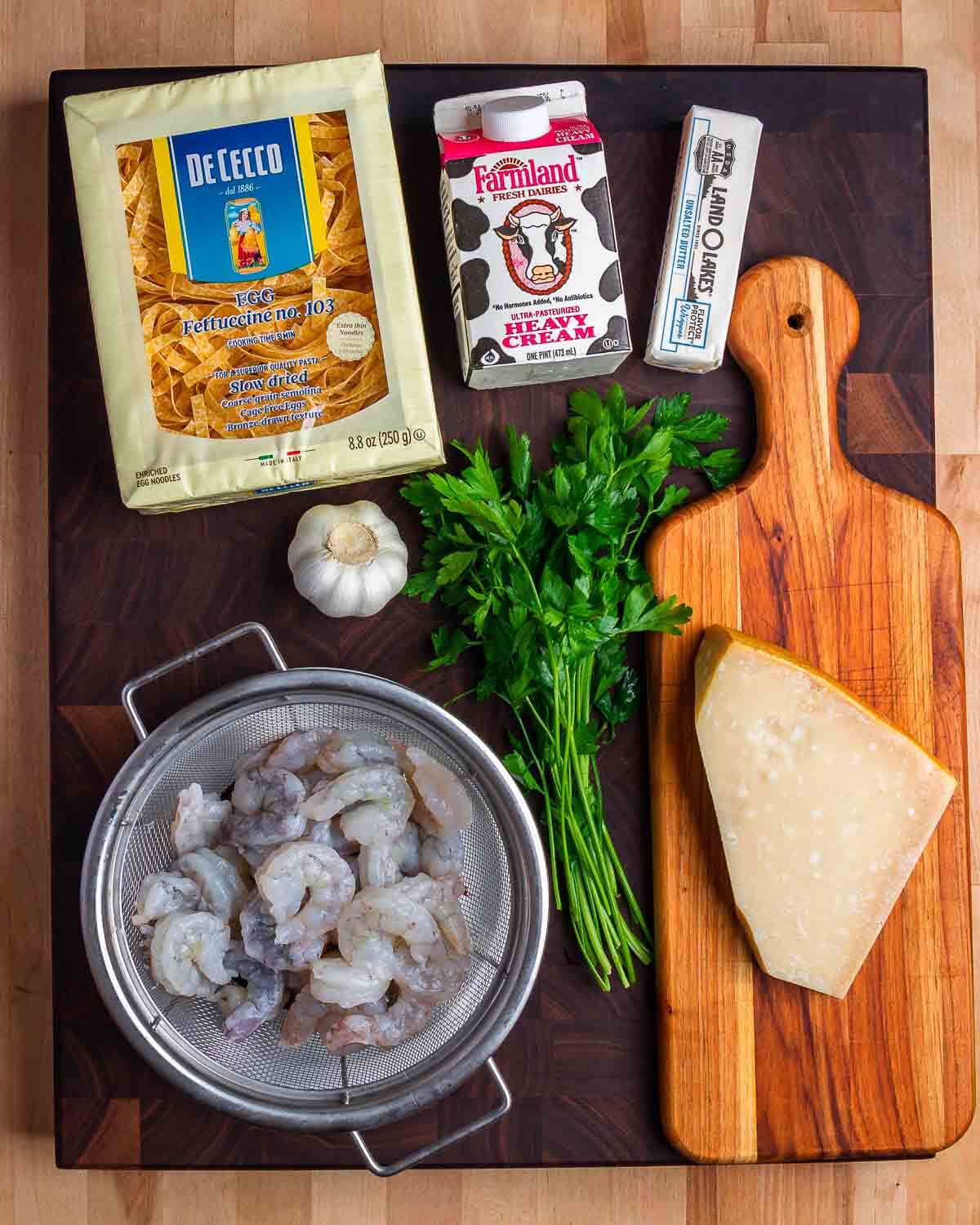 Ingredients shown: fettuccine, heavy cream, butter, garlic, shrimp, parsley, and Parmigiano Reggiano cheese.