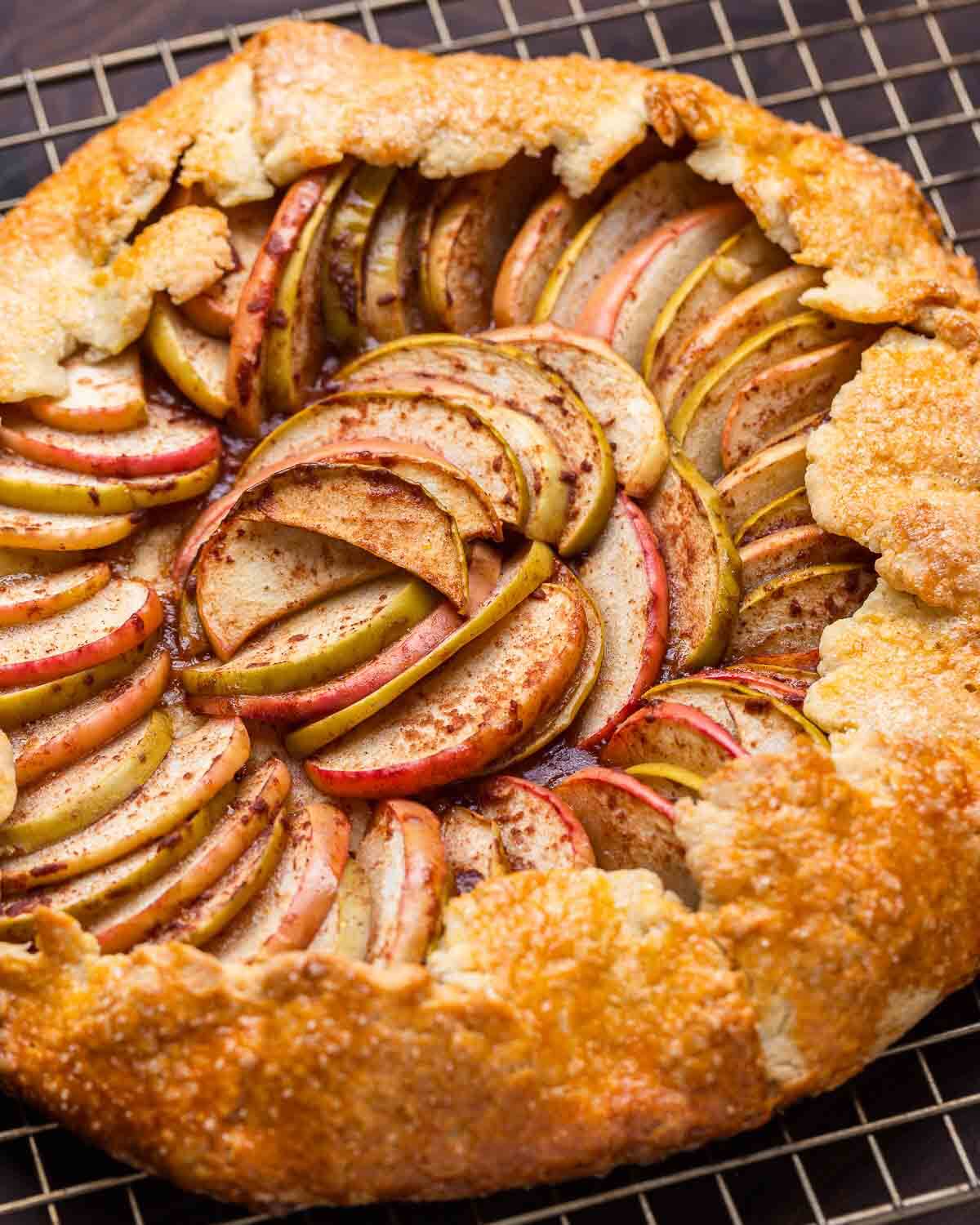 Apple crostata resting on wire rack to cool.