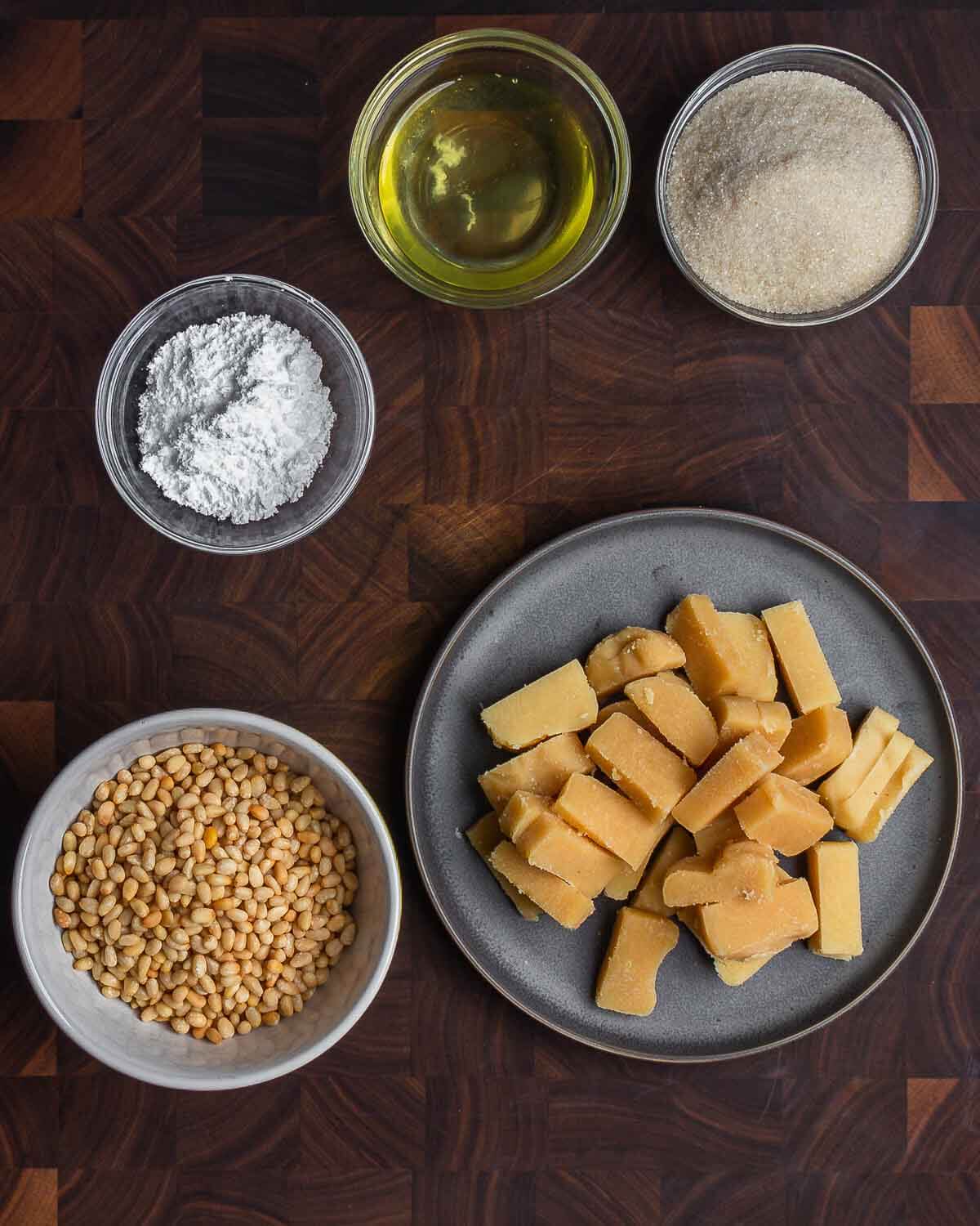 Ingredients shown: egg whites, sugar, flour, pignoli nuts, and almond paste.