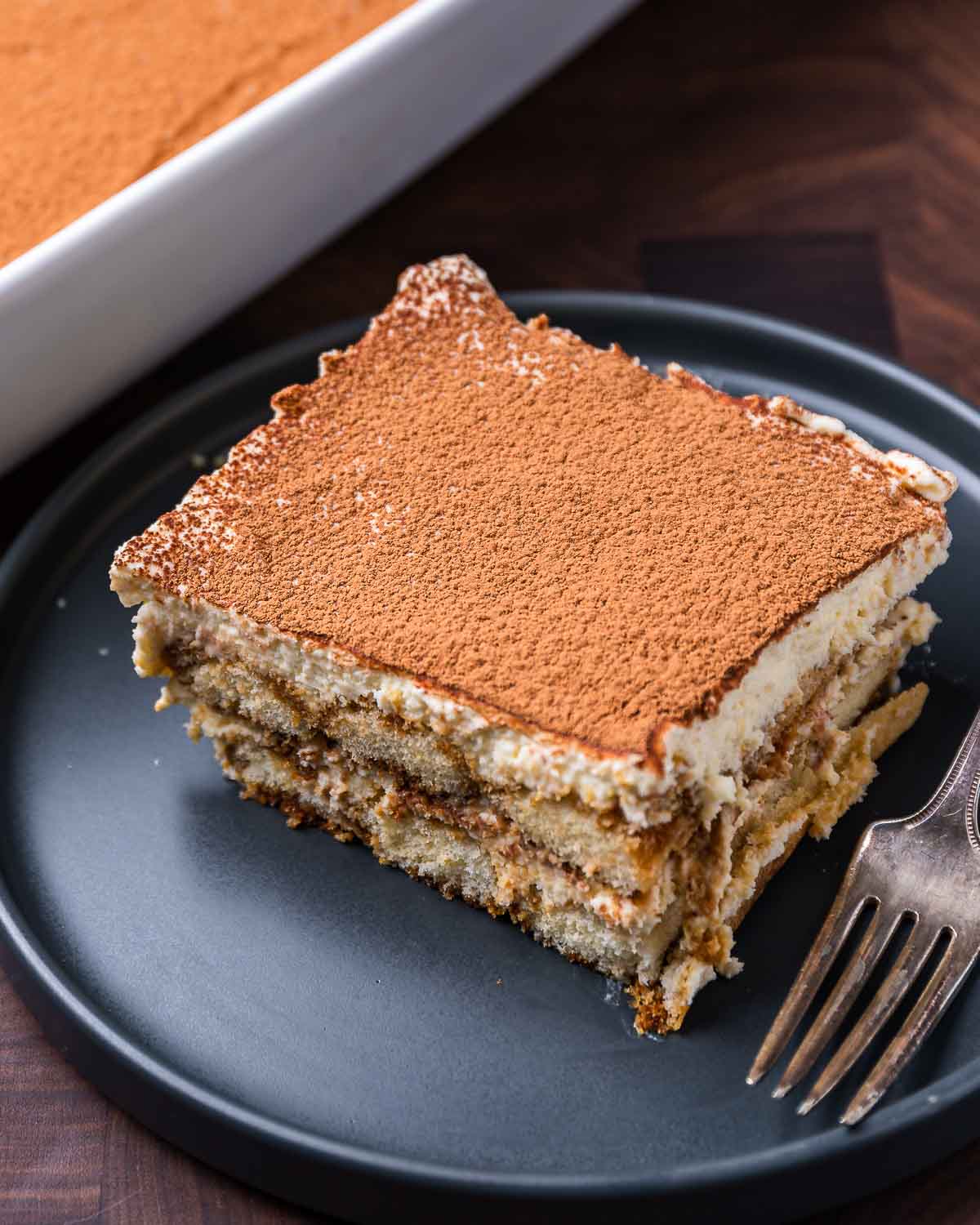 Large piece of tiramisu in blue plate.