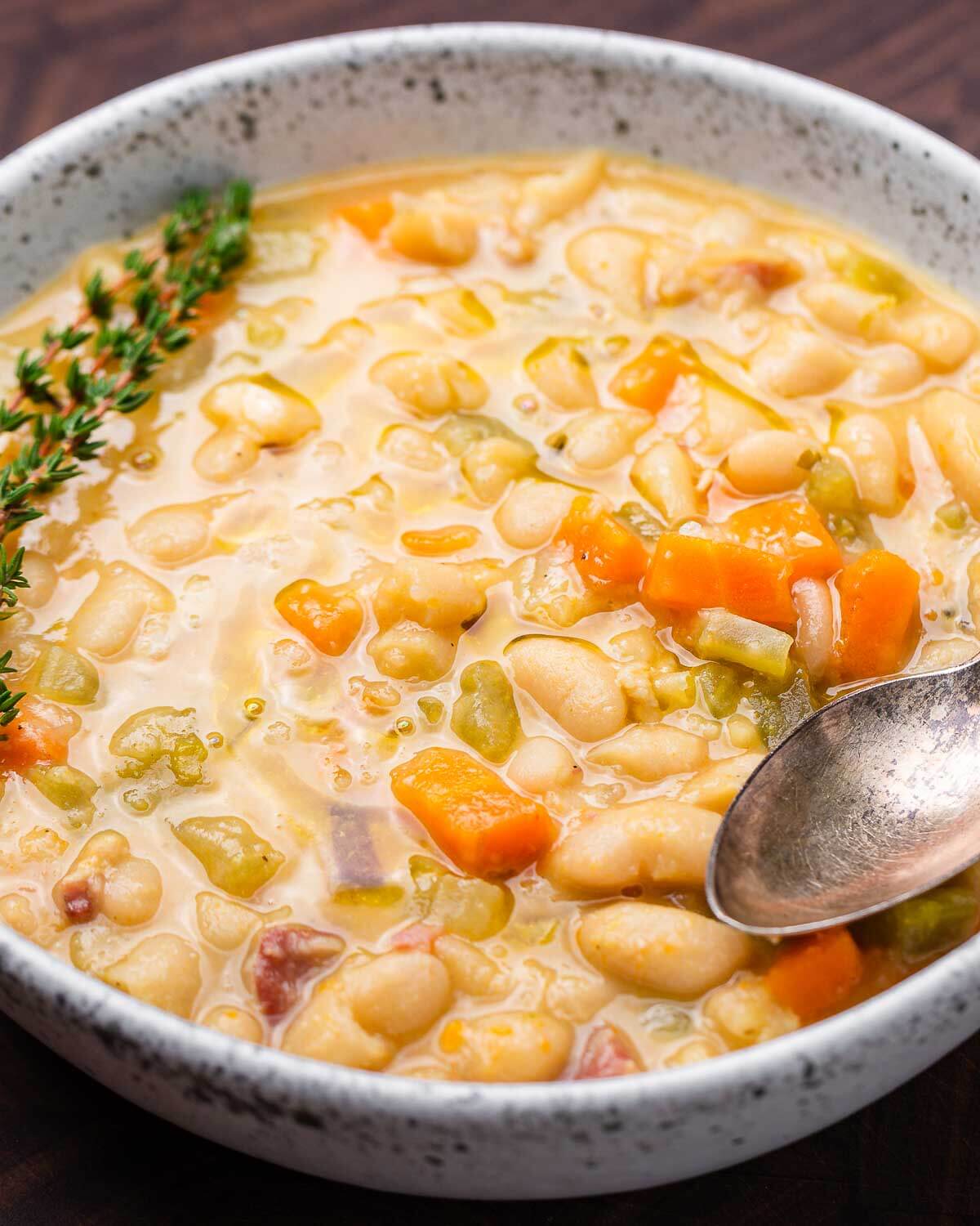 White bowl of Tuscan white bean soup.