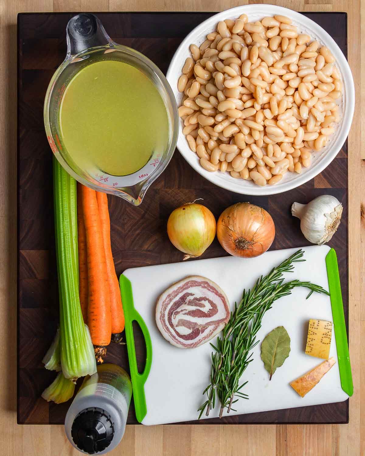 Ingredients shown: chicken stock, cannellini beans, celery, carrots, onion, garlic, olive oil, pancetta, rosemary, and Parmigiano rinds.