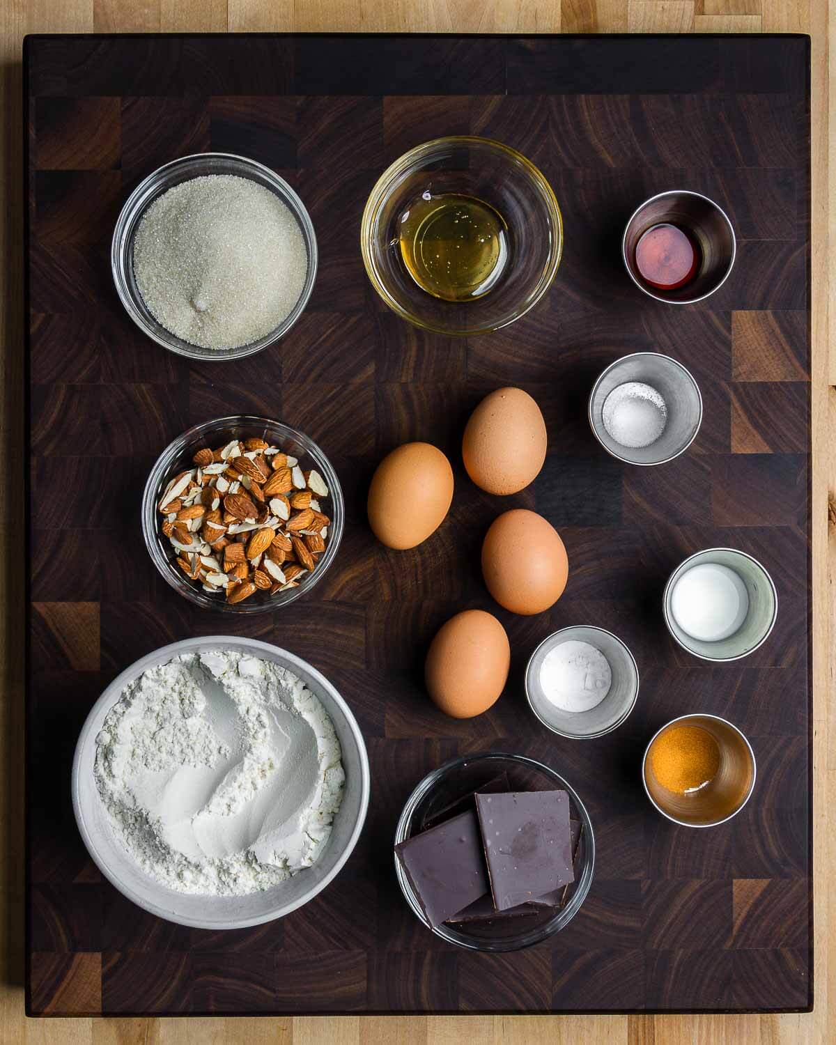 Ingredients shown: sugar, honey, vanilla extract, salt, almonds, eggs, milk, baking powder, cinnamon, flour, and chocolate.