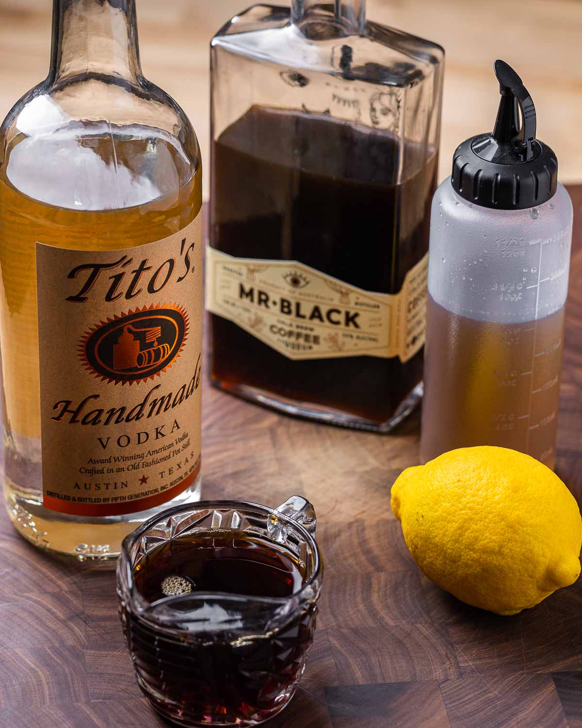 Ingredients shown: vodka, coffee liqueur, simple syrup, 1 lemon, and espresso.