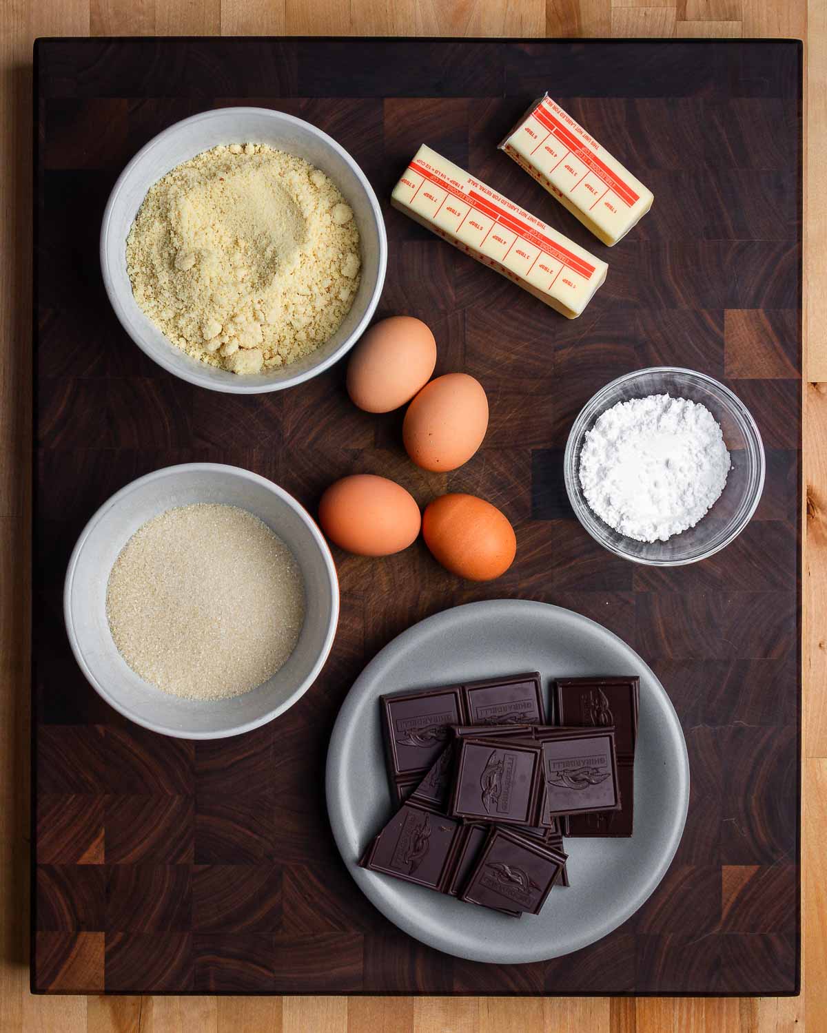 Ingredients shown: almond flour, butter, eggs, sugar, confectioner's sugar, and 70% cacao chocolate.