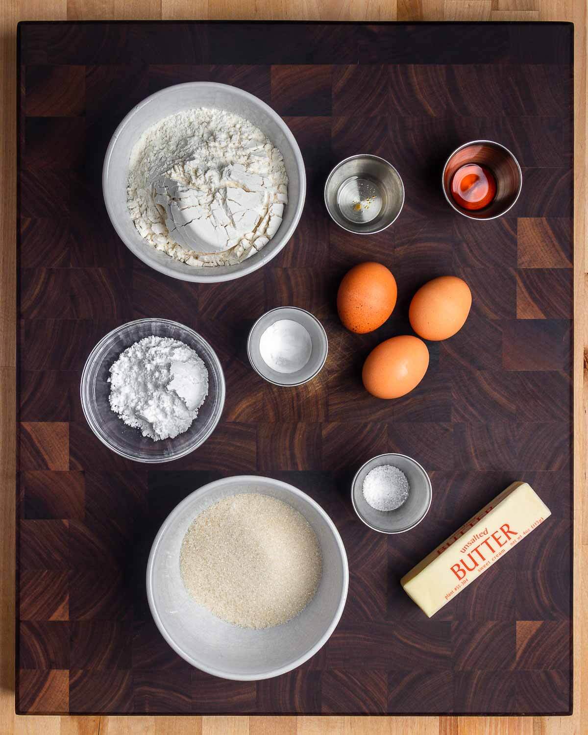 Ingredients shown: flour, anise extract, vanilla extract, powdered sugar, baking powder, eggs, sugar, salt, and butter.