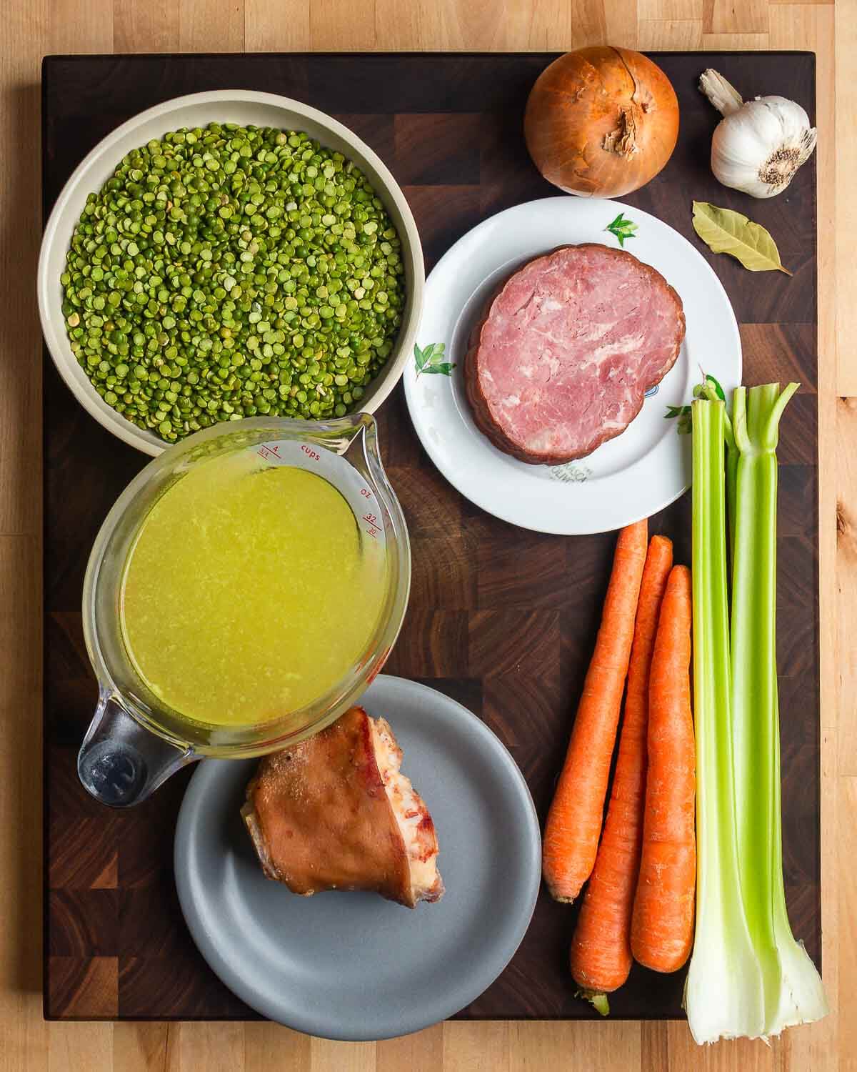 Ingredients shown: split peas, onion, garlic, bay leaf, ham, chicken stock, ham hock, carrots, and celery.