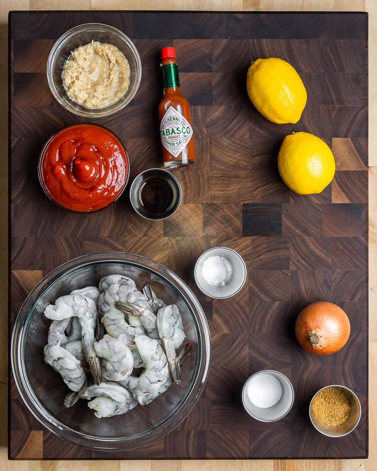 Ingredients shown: horseradish, Tabasco, ketchup, Worcestershire sauce, lemons, shrimp, baking soda, salt, onion, and Old Bay seasoning.