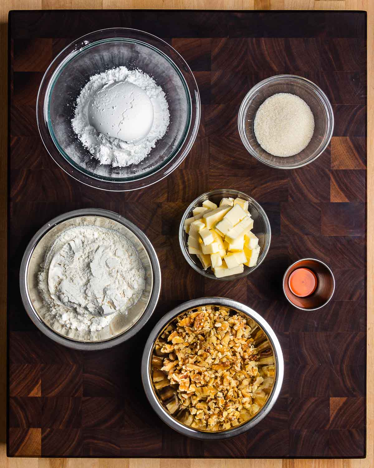 Ingredients shown: powdered and granulated sugar, flour, butter, vanilla extract, and chopped walnuts.