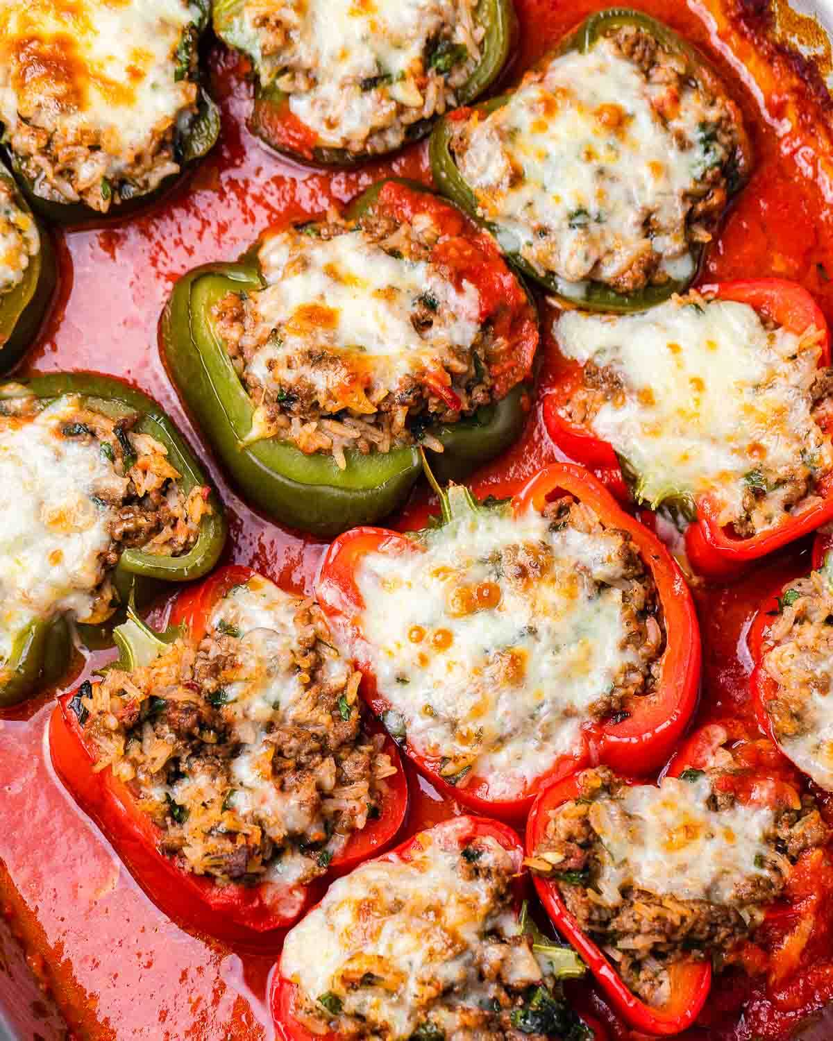Overhead shot of red and green Italian stuffed peppers.