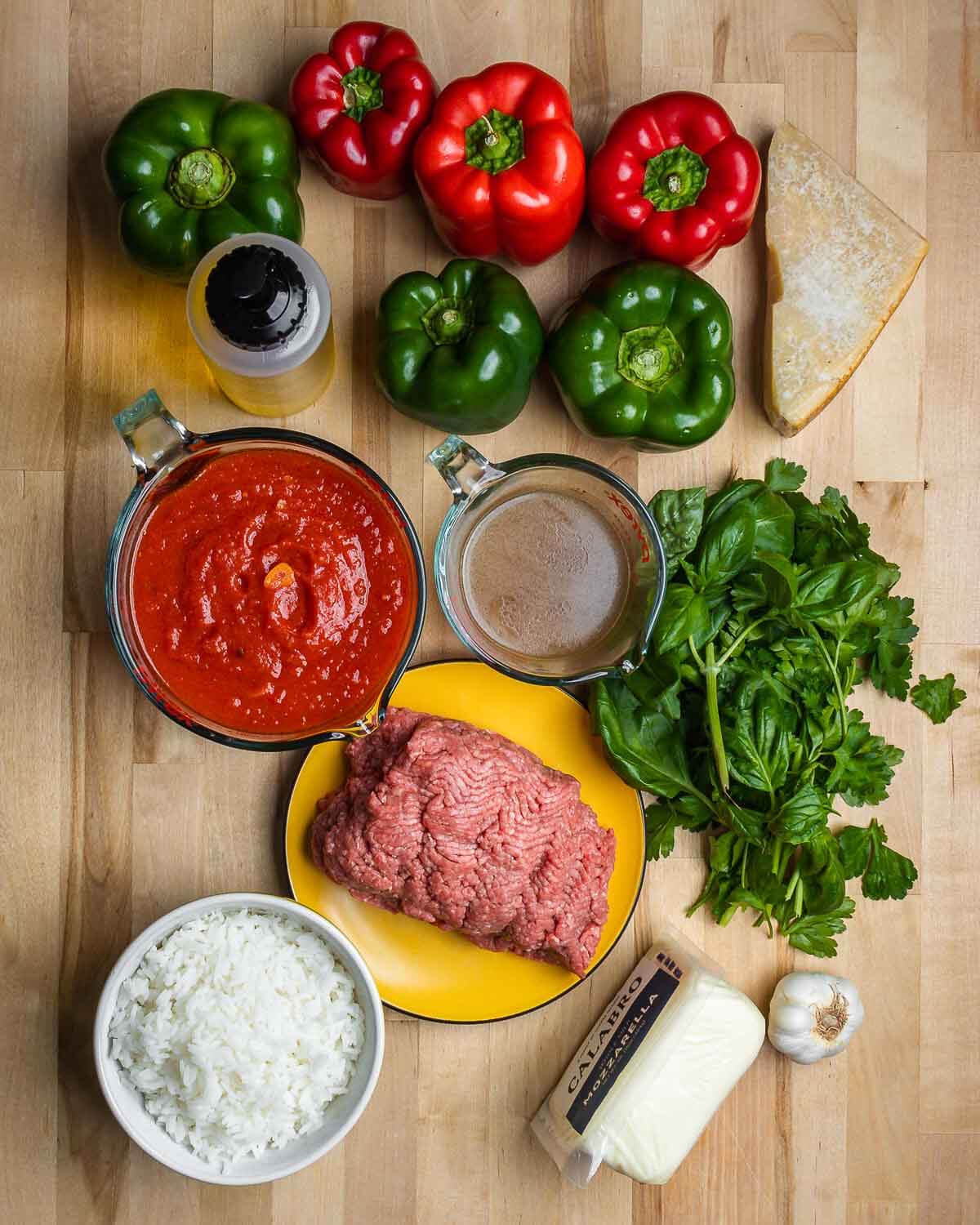 Ingredients shown: bell peppers, Pecorino, olive oil, marinara sauce, beef stock, parsley, basil, ground chuck, rice, mozzarella, and garlic.