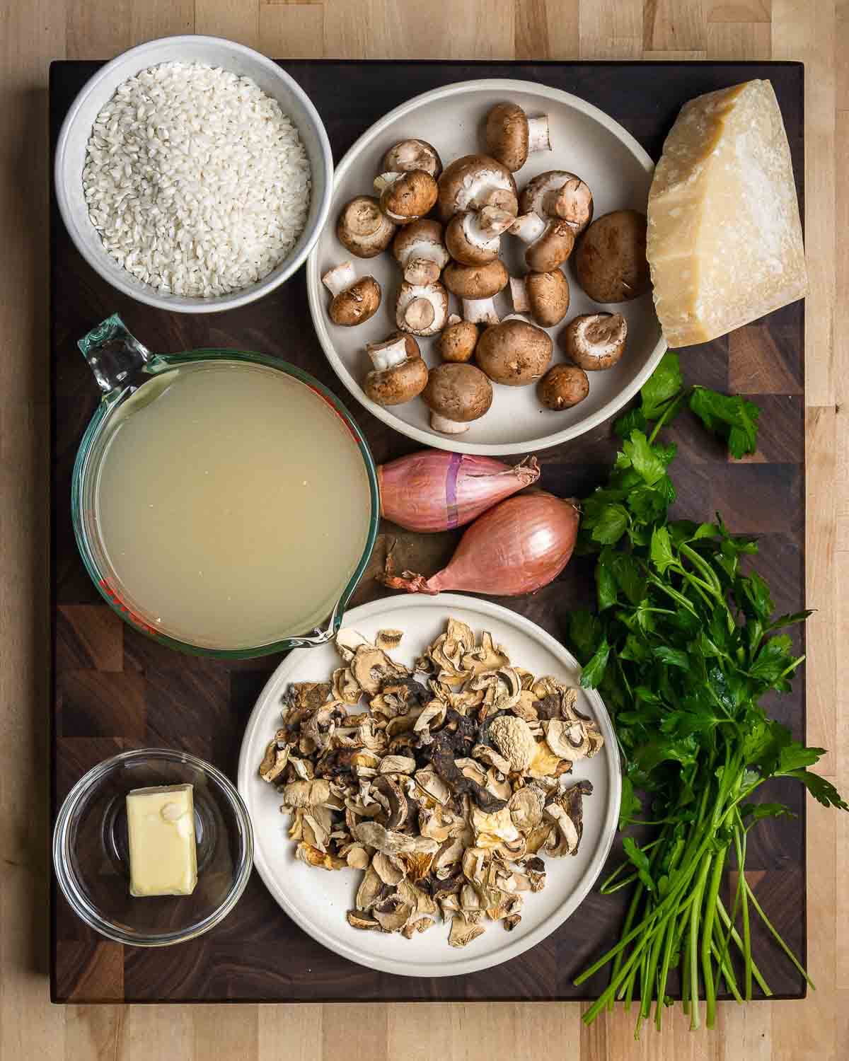 Ingredients shown: arborio rice, cremini mushrooms, Parmigiano Reggiano, chicken stock, shallots, butter, assorted dried mushrooms, and parsley.