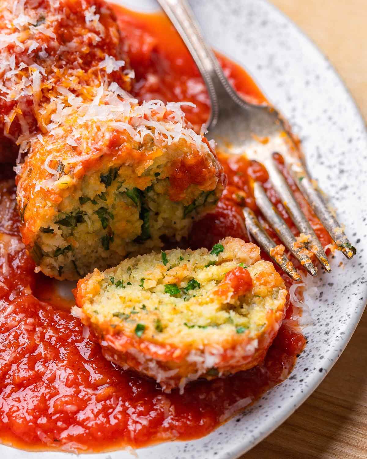 White plate of cut open polpette di pane.