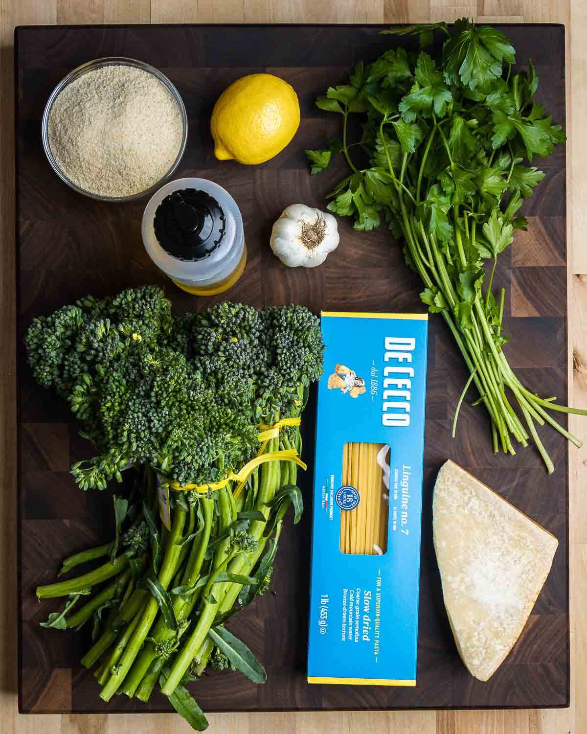 Ingredients shown: breadcrumbs, lemon, olive oil, garlic, parsley, broccolini, linguine, and Parmigiano Reggiano.