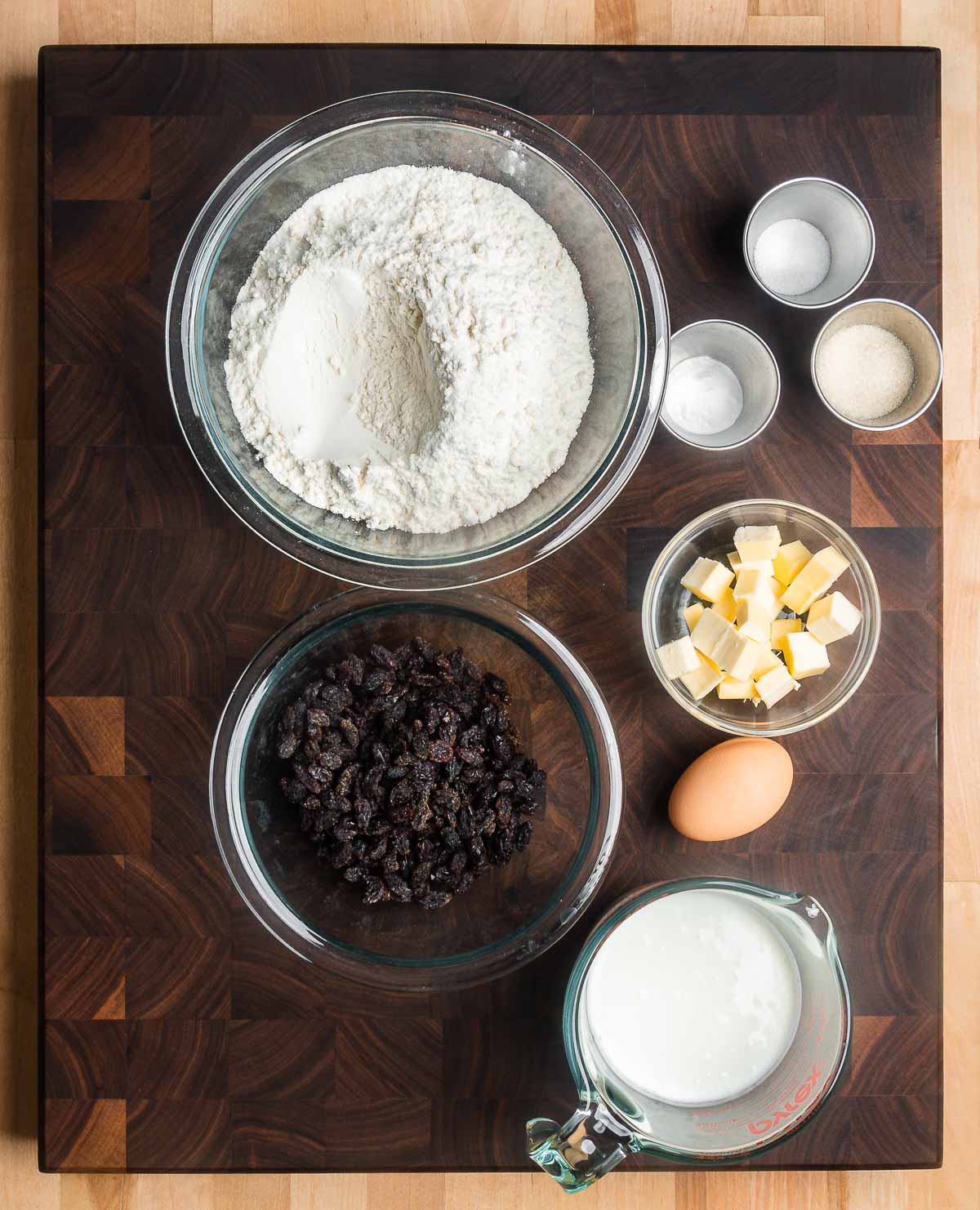 Ingredients shown: flour, sugar, baking soda, baking powder, salt, butter, buttermilk, egg, and raisins.