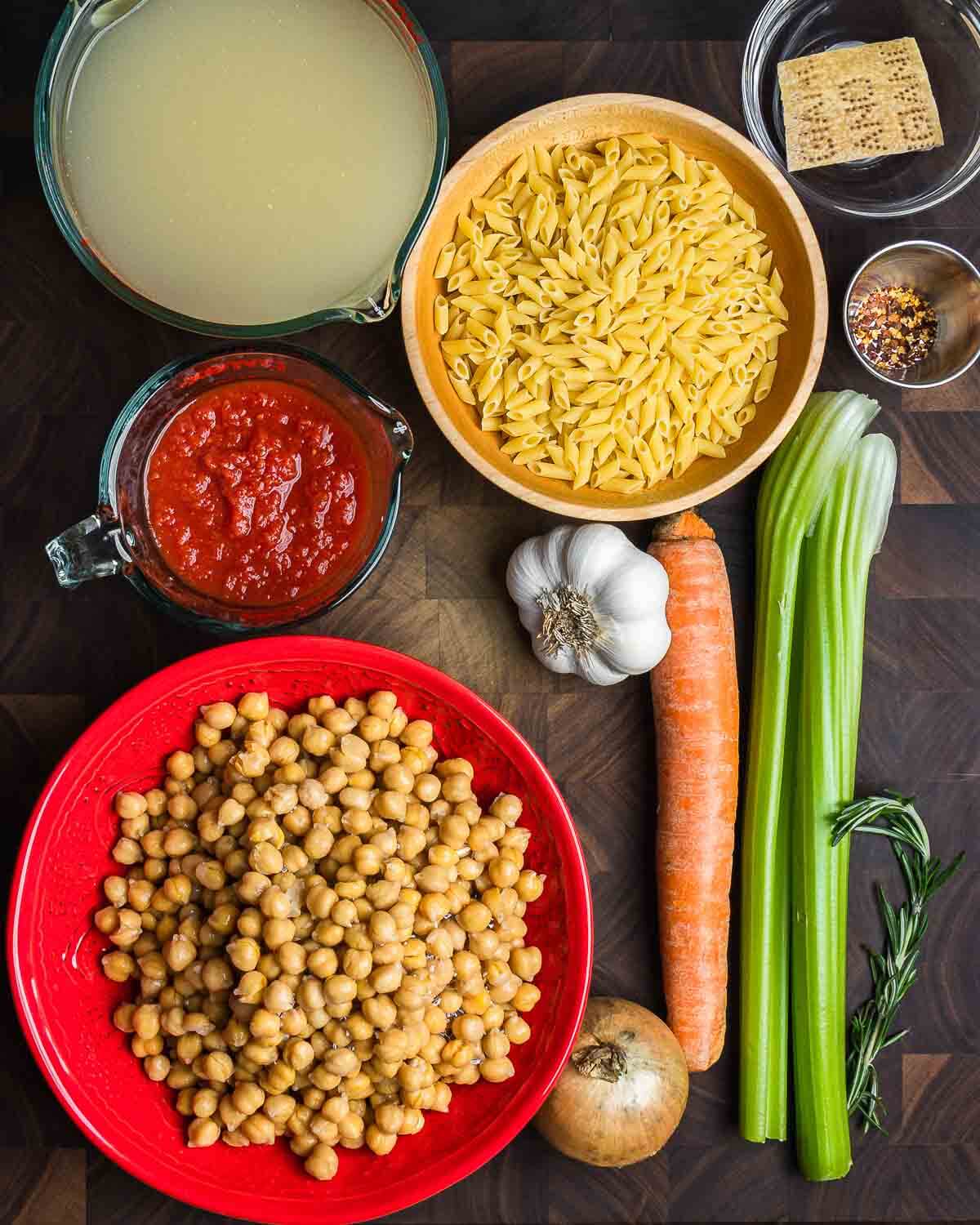 Ingredients shown: vegetable stock, small pasta, parmesan rind, hot red pepper flakes, crushed tomatoes, garlic, carrot, celery, chickpeas, onion, and rosemary.