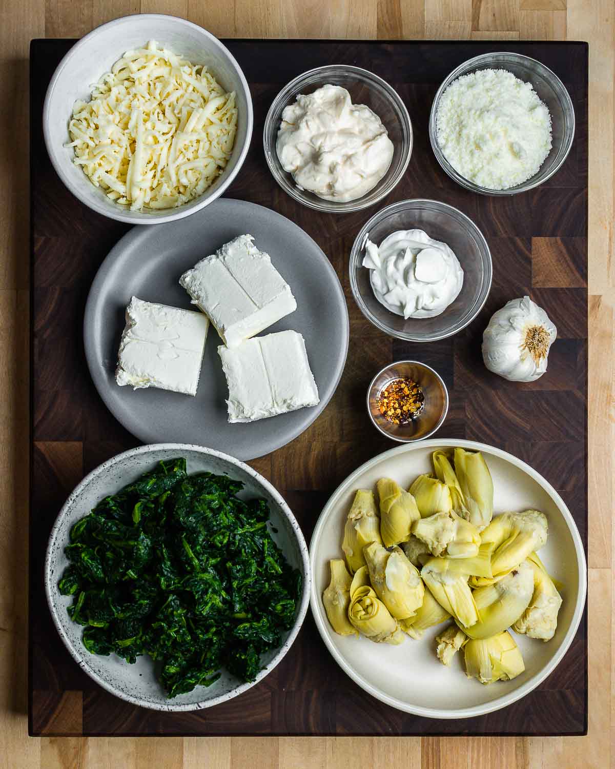 Ingredients shown: mozzarella, mayo, Pecorino, cream cheese, sour cream, hot red pepper flakes, garlic, spinach, and artichoke hearts.