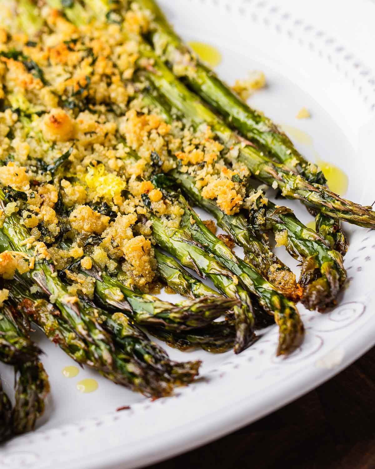 Baked asparagus on white plate.